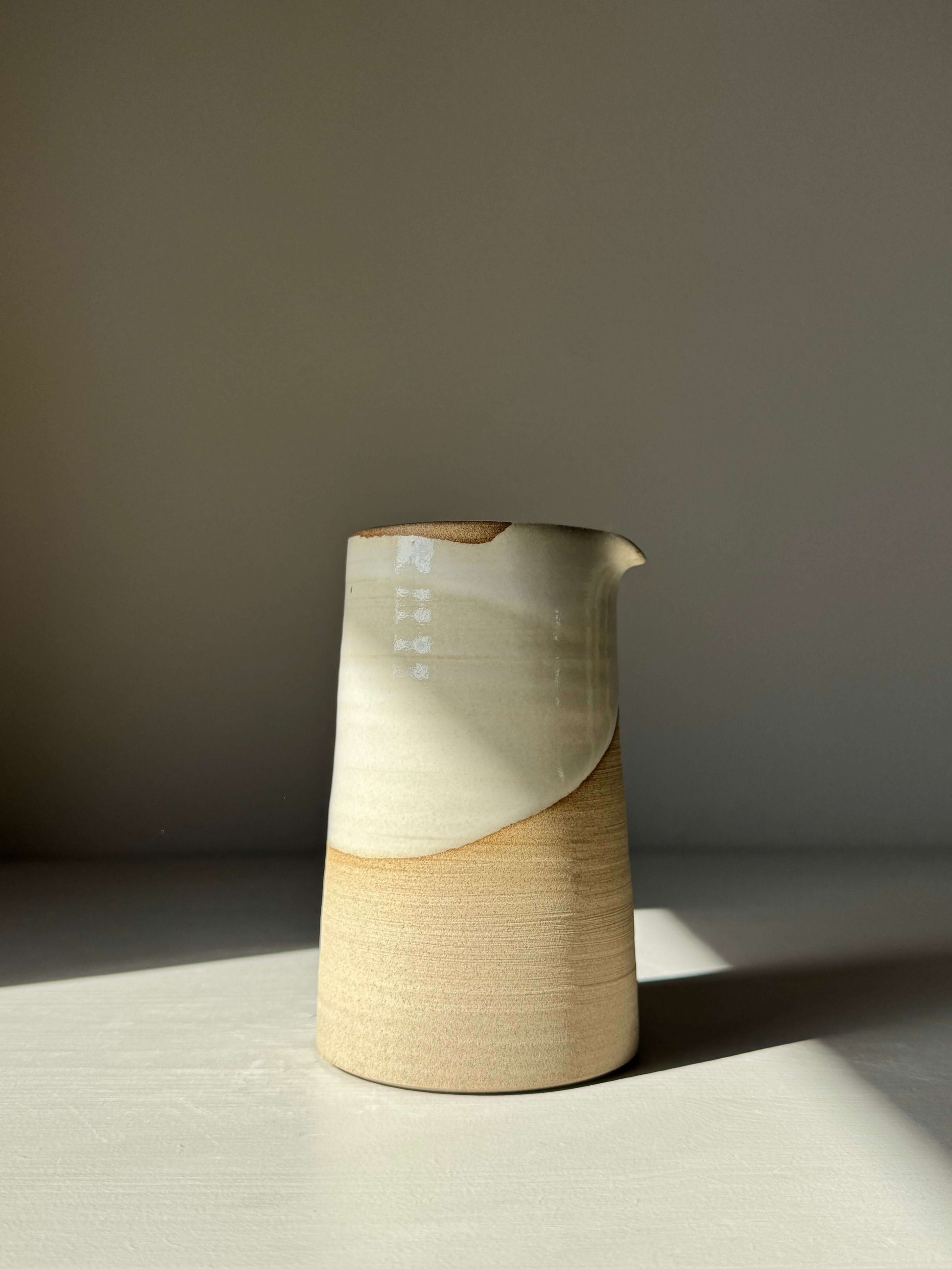Medium Vase / Jug – Yuki Series, handmade ceramic with a glossy white glaze on top and raw toffee-colored clay base, elegant design.