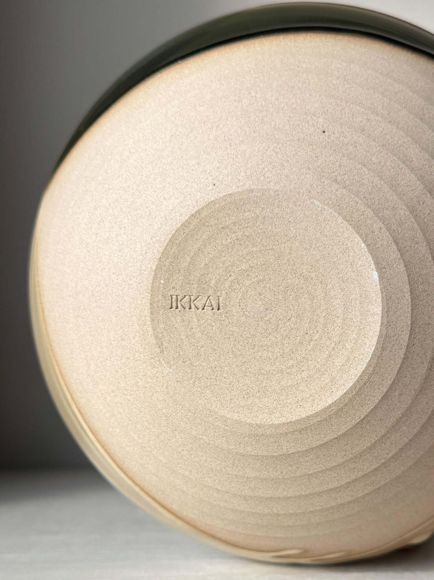 Underside view of a Medium Bowl - Mori #02 showing its raw toffee-colored clay base with textured circular patterns, handmade ceramic.