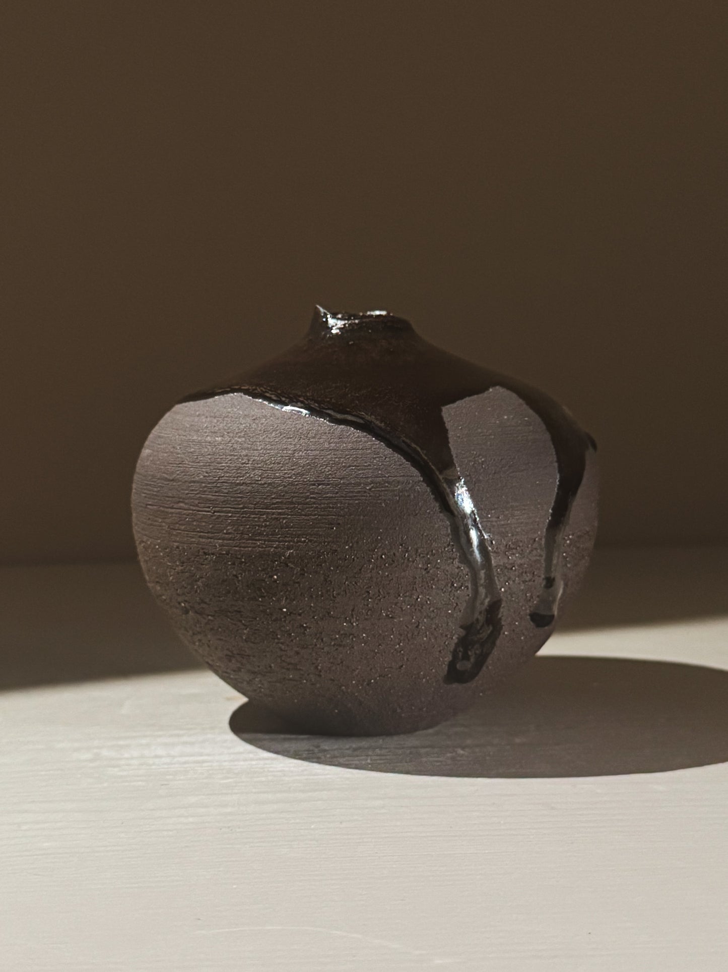 Orb Vase – Kuro Black #02 featuring a unique rounded shape and organic glaze patterns.