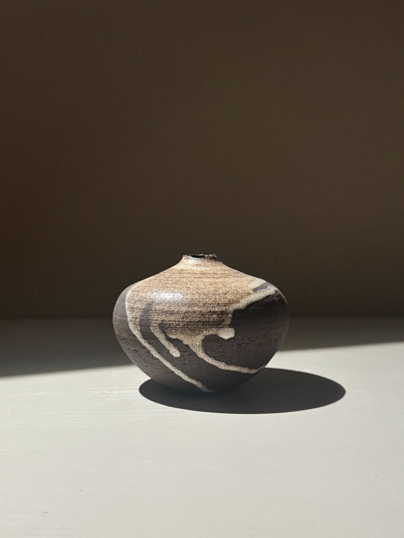 Orb Vase – Matt Clear with organic patterns and soft spherical form, showcasing unique glaze movement.