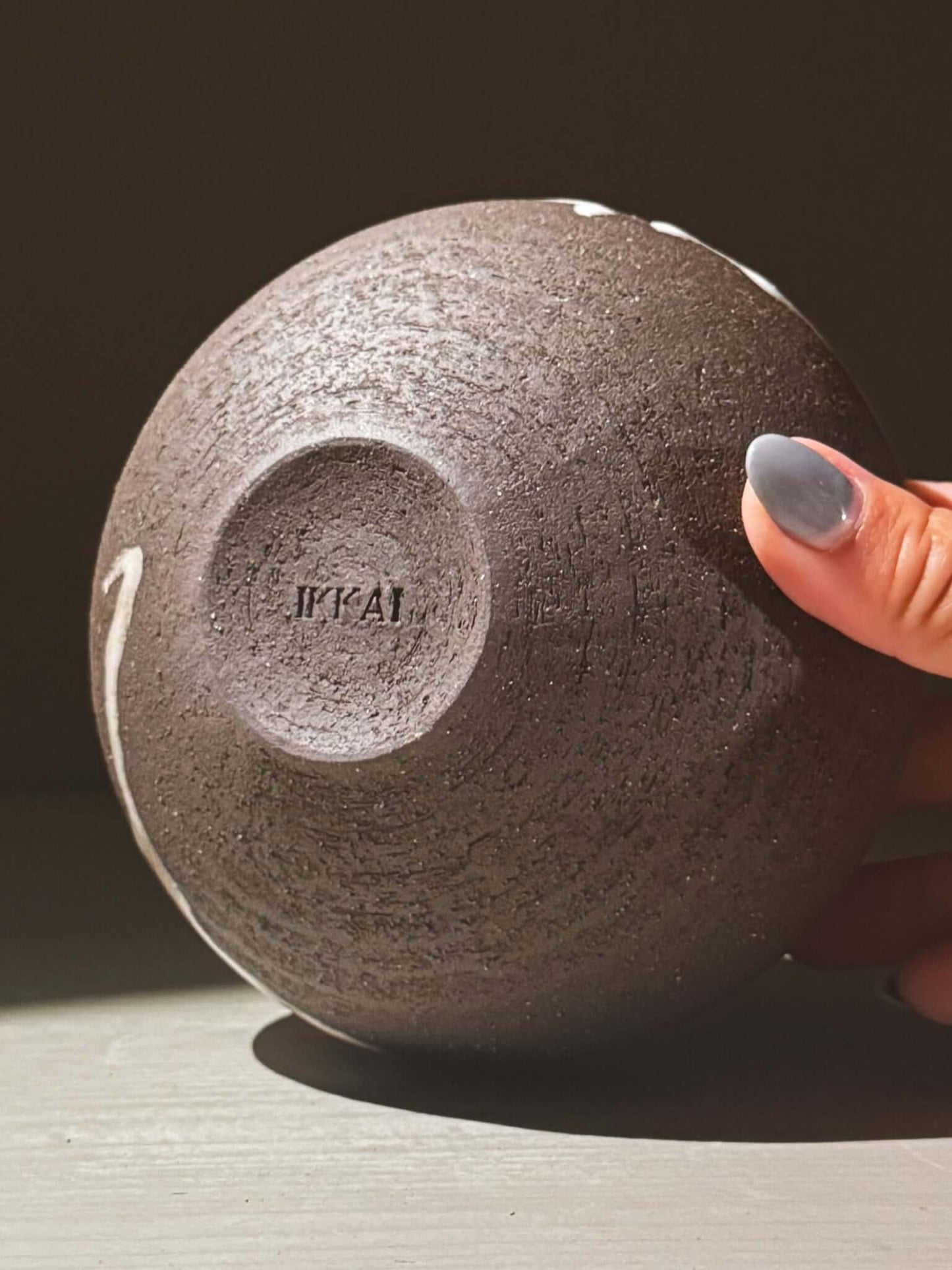 Orb Vase – Yuki Black #03, showing the unique texture and design of the base, emphasizing its sculptural form.
