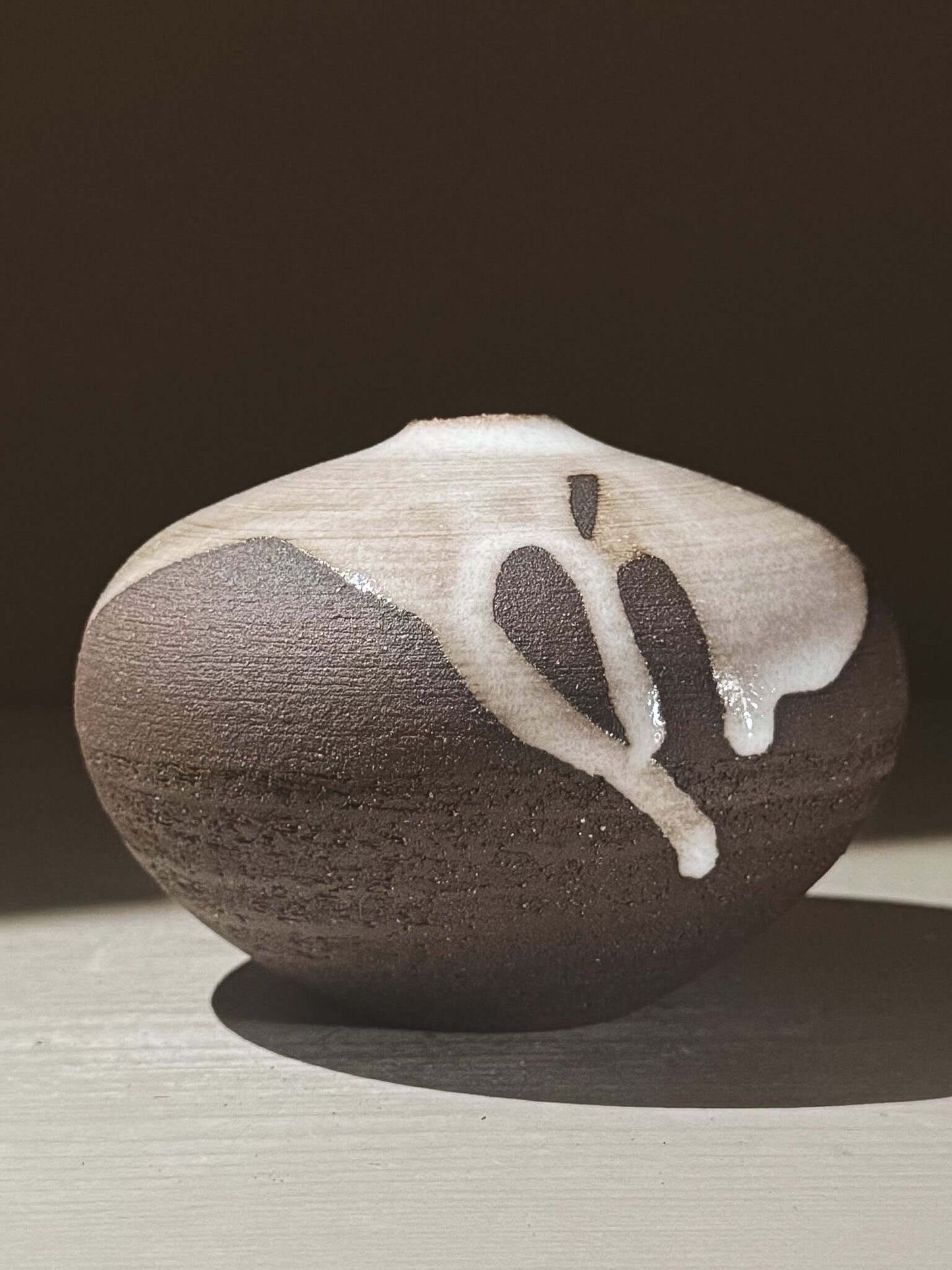 Orb Vase – Yuki Black #06 showcasing unique glaze patterns and rounded shape.