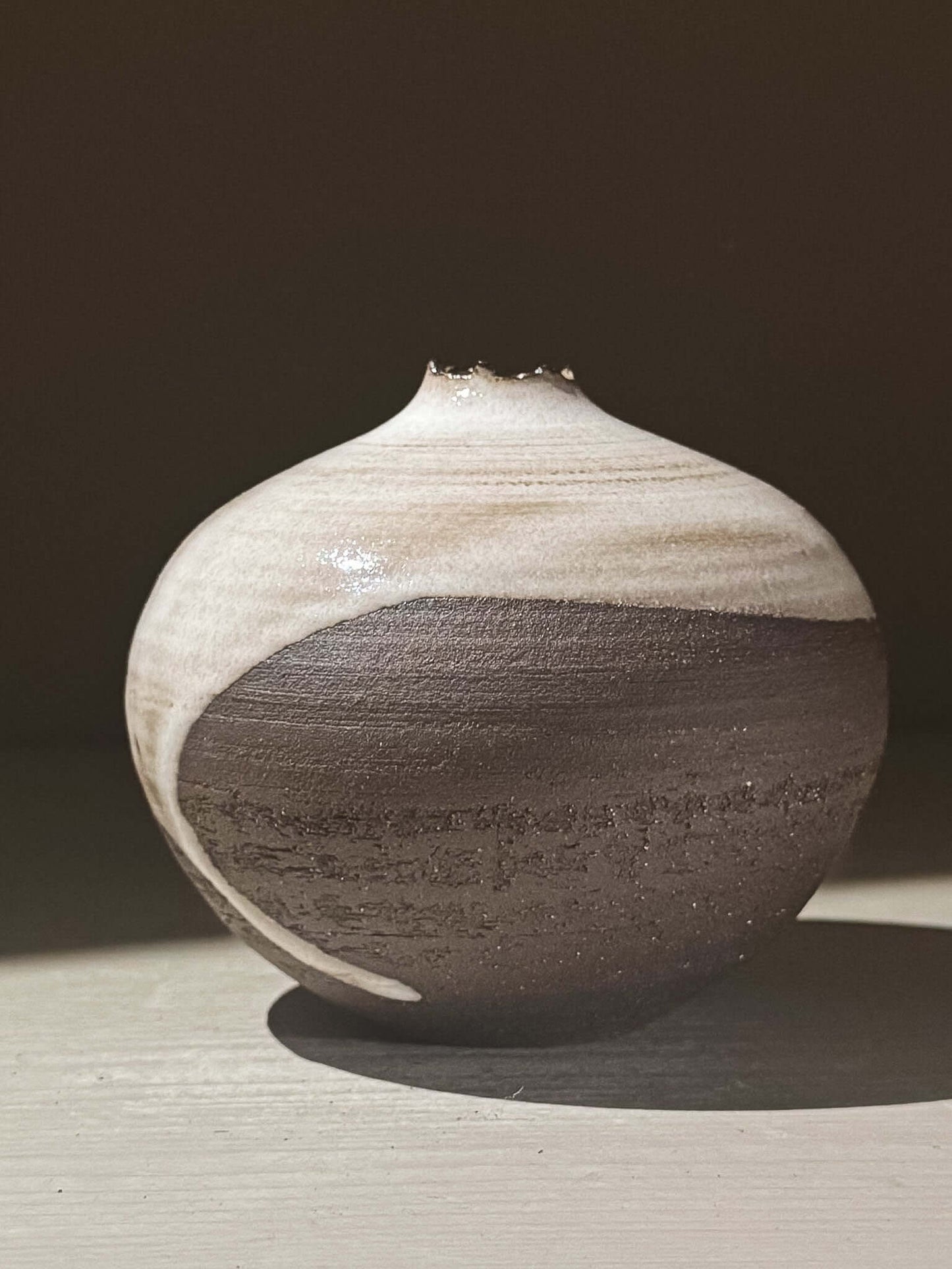Orb Vase – Yuki Black #08 with unique glaze patterns and soft spherical form, showcasing its artistic craftsmanship.