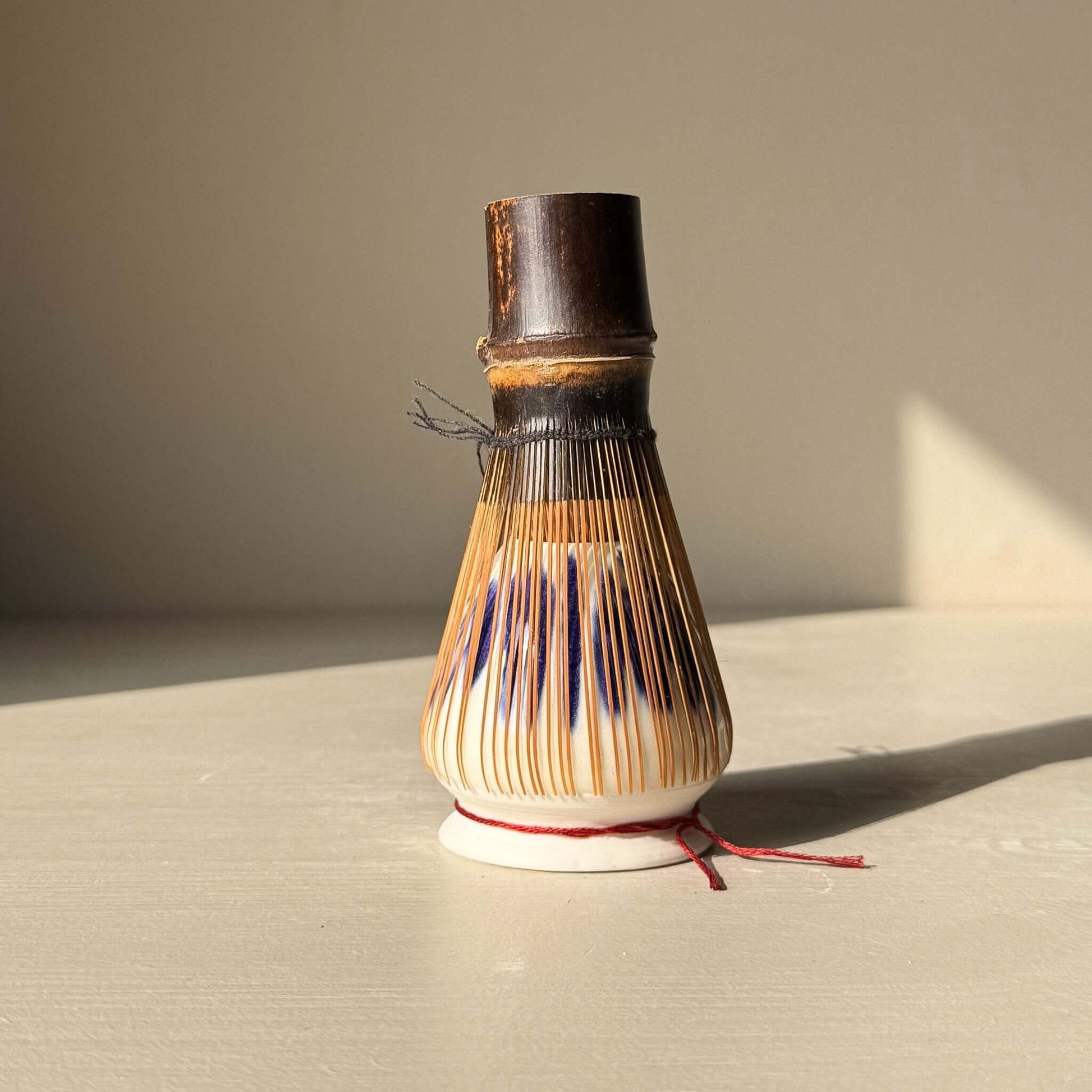 Porcelain Whisk Holder – Cobalt & Gold Lustre showcasing a bamboo whisk holder with expressive cobalt blue details.