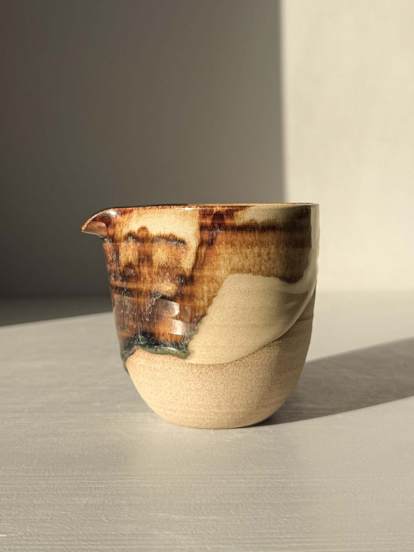 Handmade ceramic Pouring Jug – Inyo Series #02 with glossy tenmoku and clear glaze over toffee clay, ideal for sauces or milk.