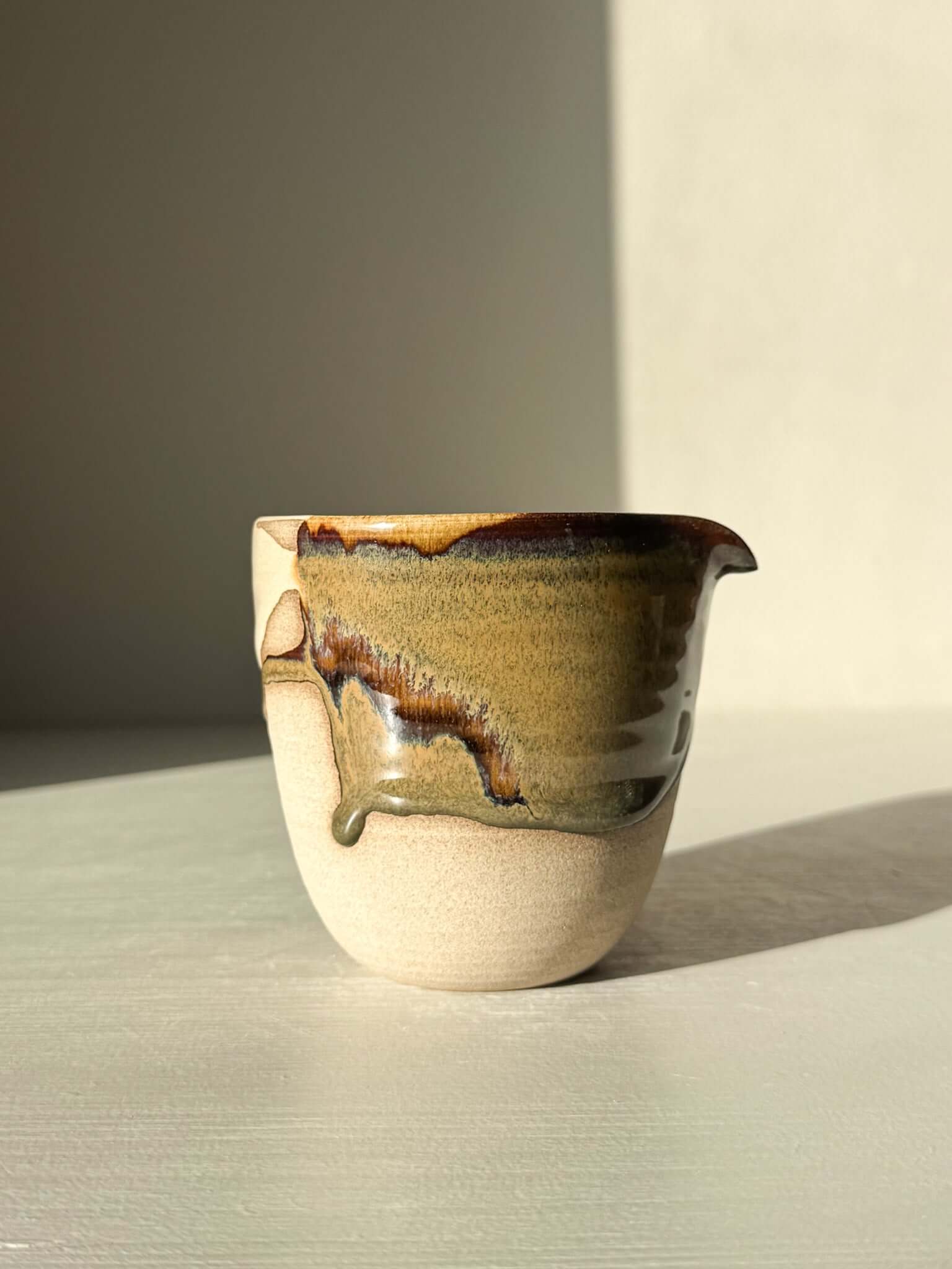 Handmade ceramic Pouring Jug – Inyo Series #01 with glossy tenmoku and clear glaze over toffee clay, ideal for sauces and milk.