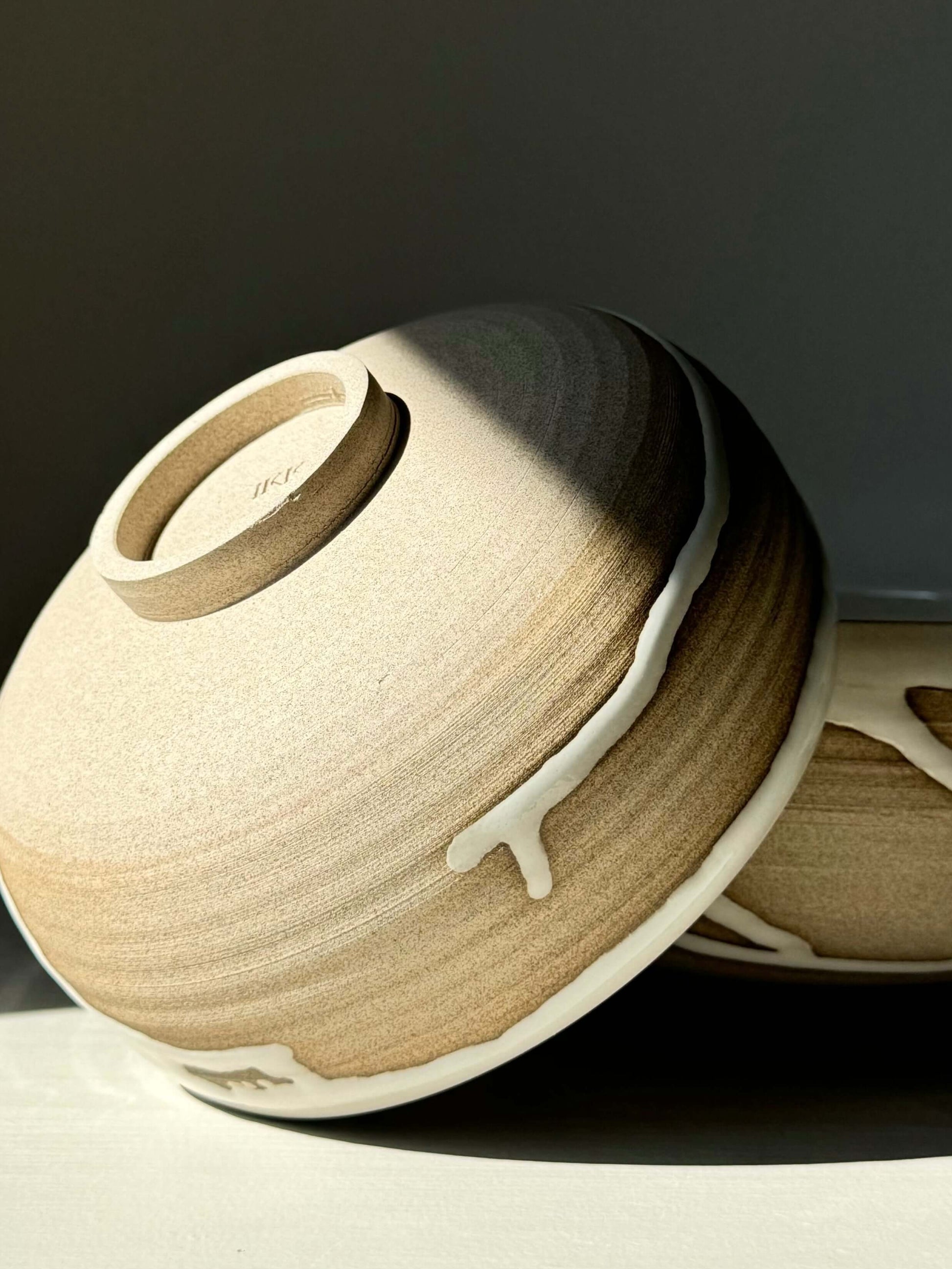 Handcrafted Yuki Series breakfast bowl in toffee clay with glossy white glaze, showcasing unique artisan design.