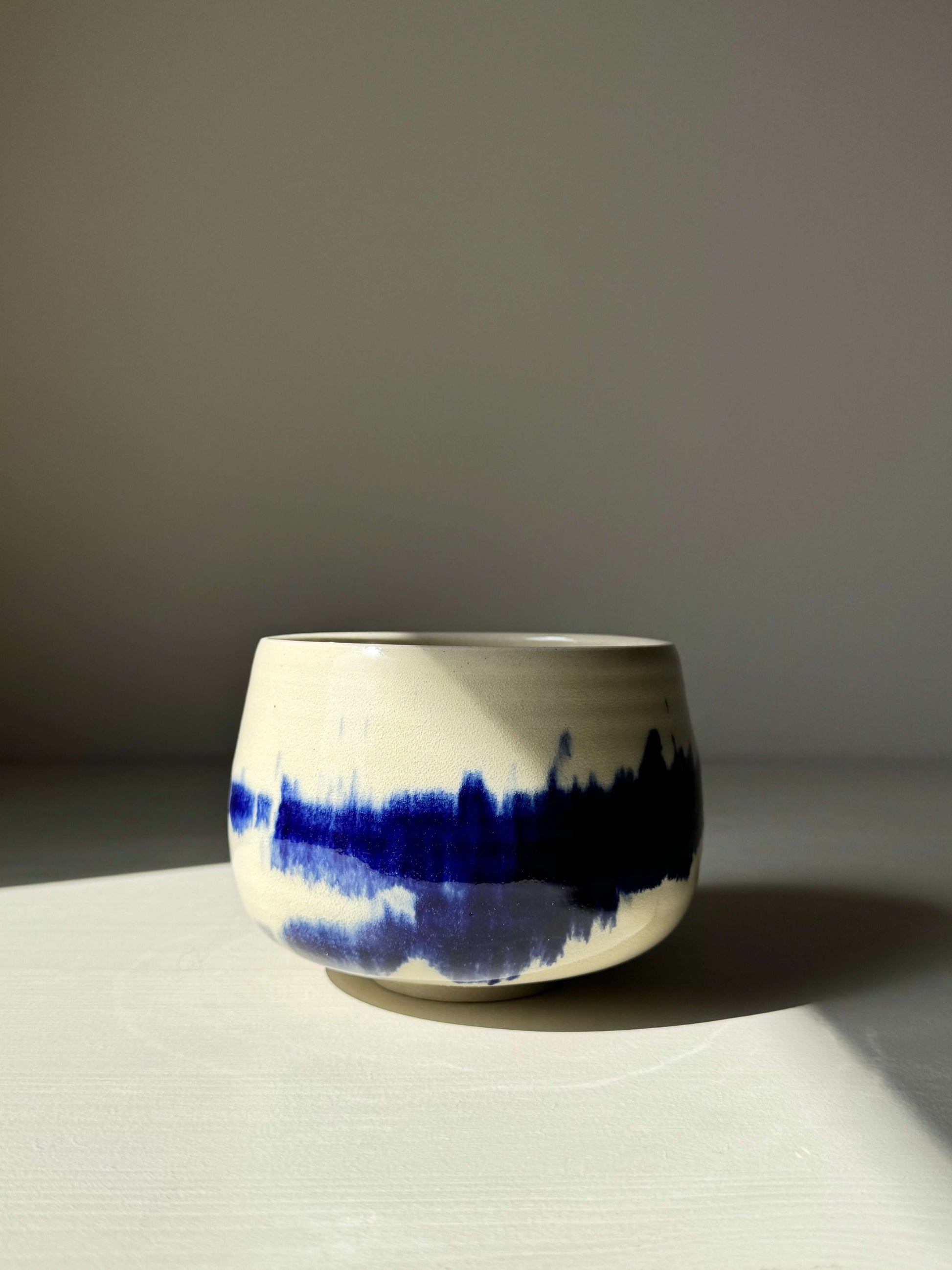 Rounded Matcha Bowl from Gosu Series with cobalt glaze and soft curves, resembling distant trees or mountains.
