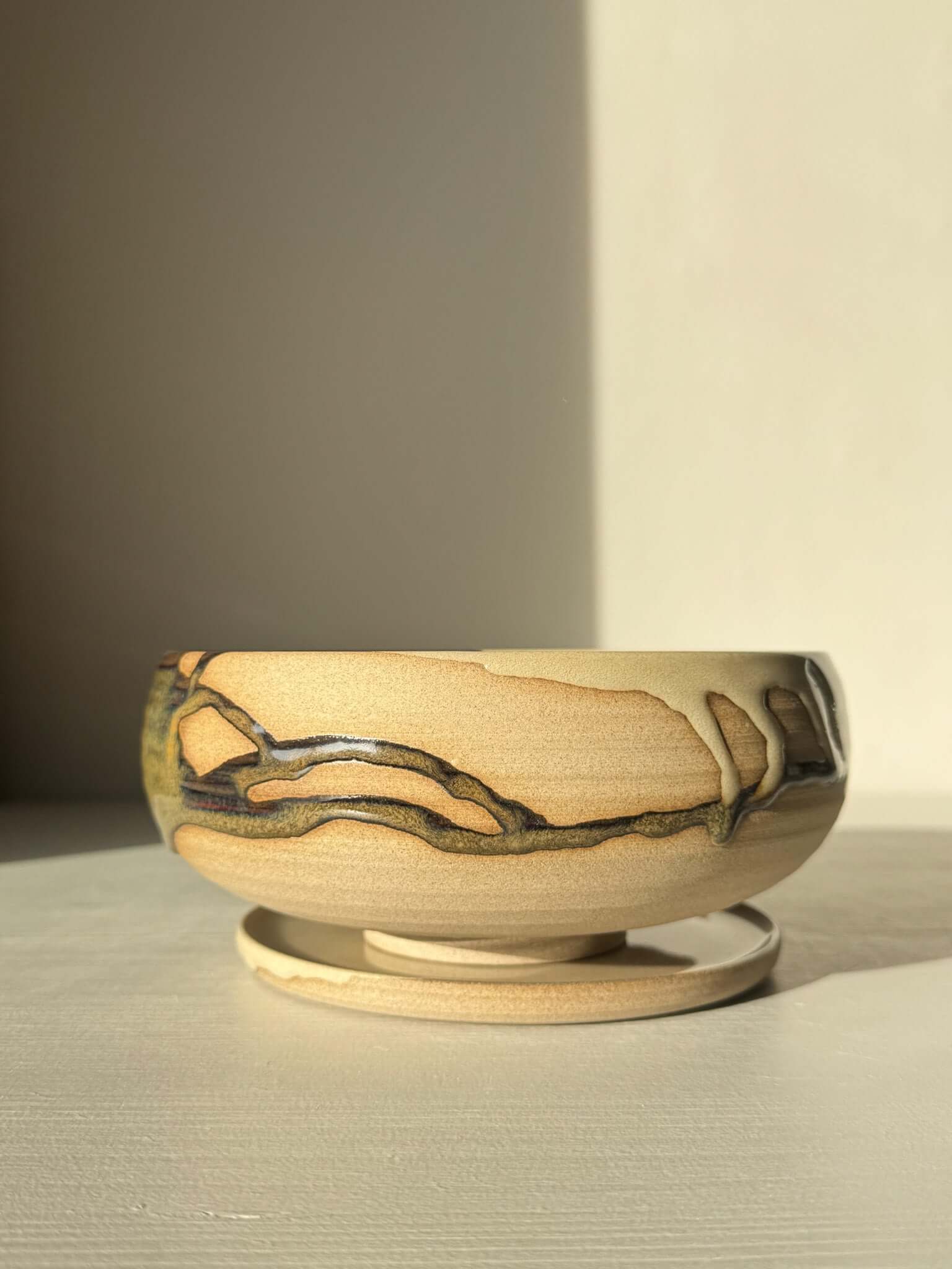 Rounded Berry Bowl - Inyo #02 with a drip plate, in earthy tones, ideal for serving fresh fruits, crafted with glossy tenmoku glaze.