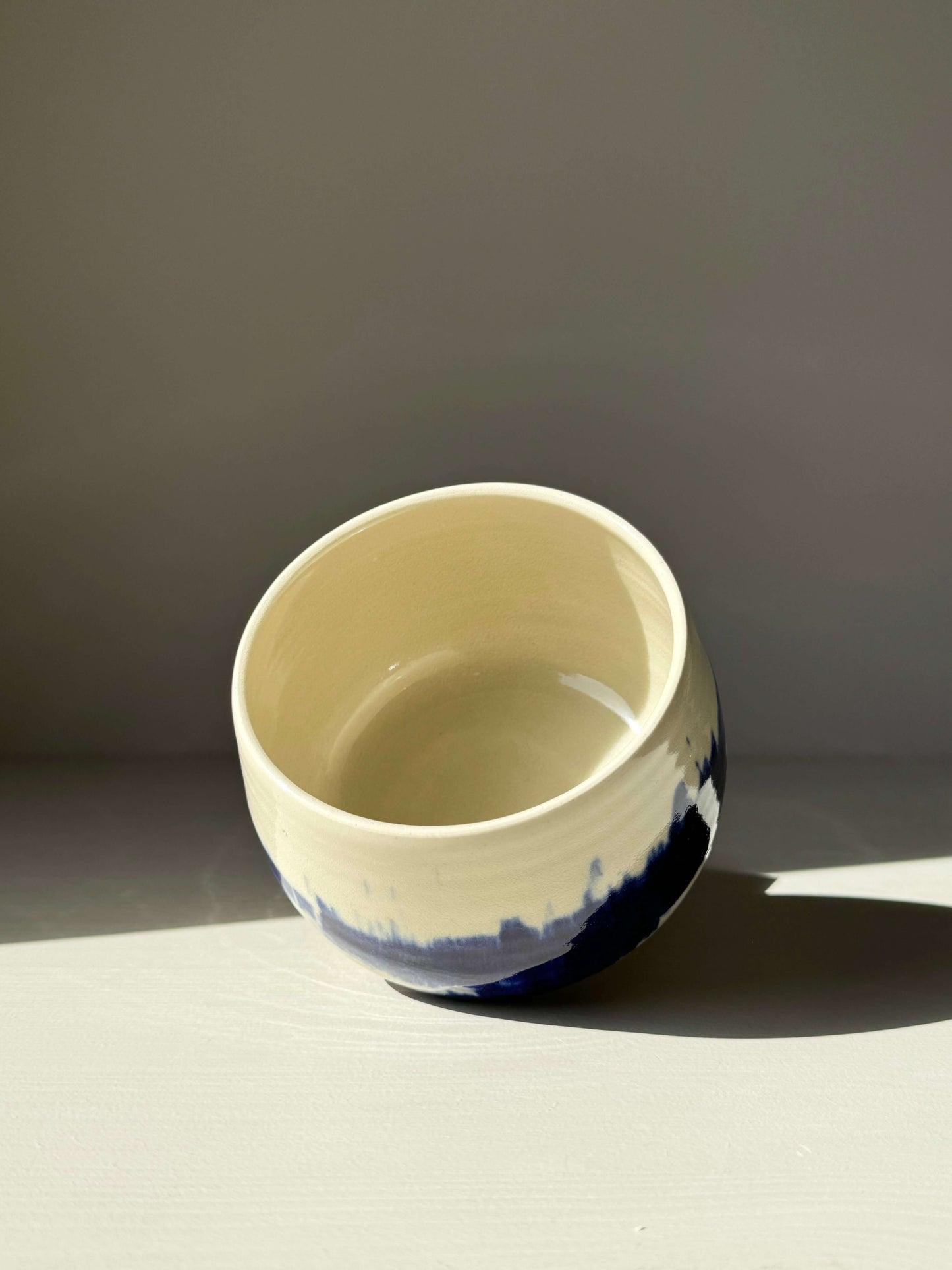 Rounded Matcha Bowl with cobalt glaze from the Gosu Series, featuring dramatic blue patterns resembling distant trees or mountain peaks.