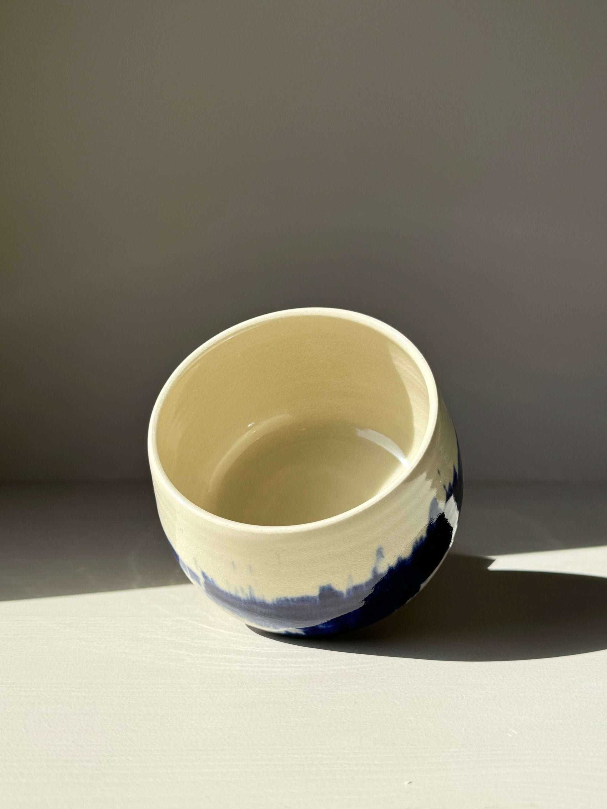 Rounded Matcha Bowl with cobalt glaze from the Gosu Series, featuring dramatic blue patterns resembling distant trees or mountain peaks.