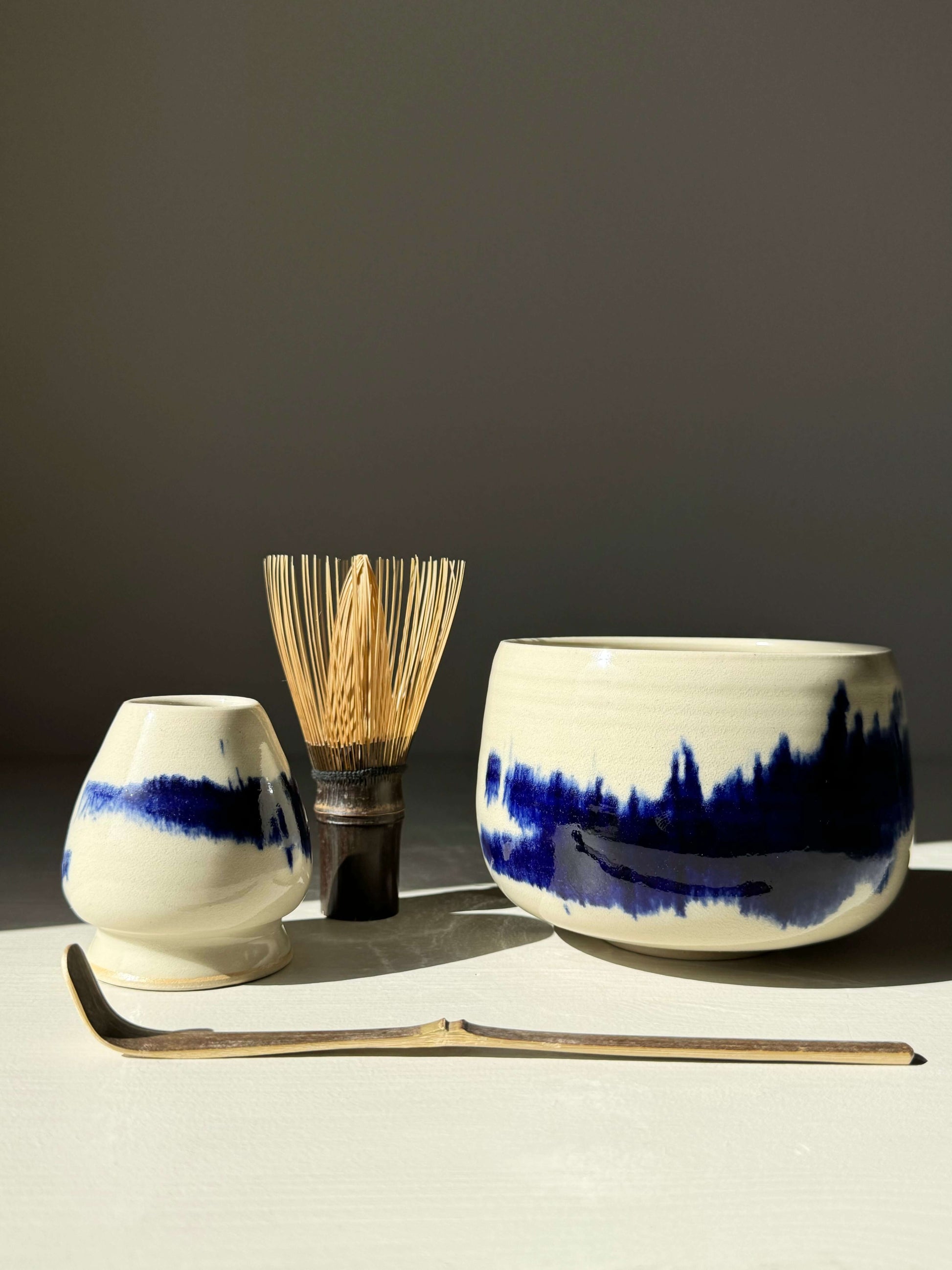 Rounded Matcha Bowl with cobalt glaze from Gosu Series, paired with a chasen and scoop.