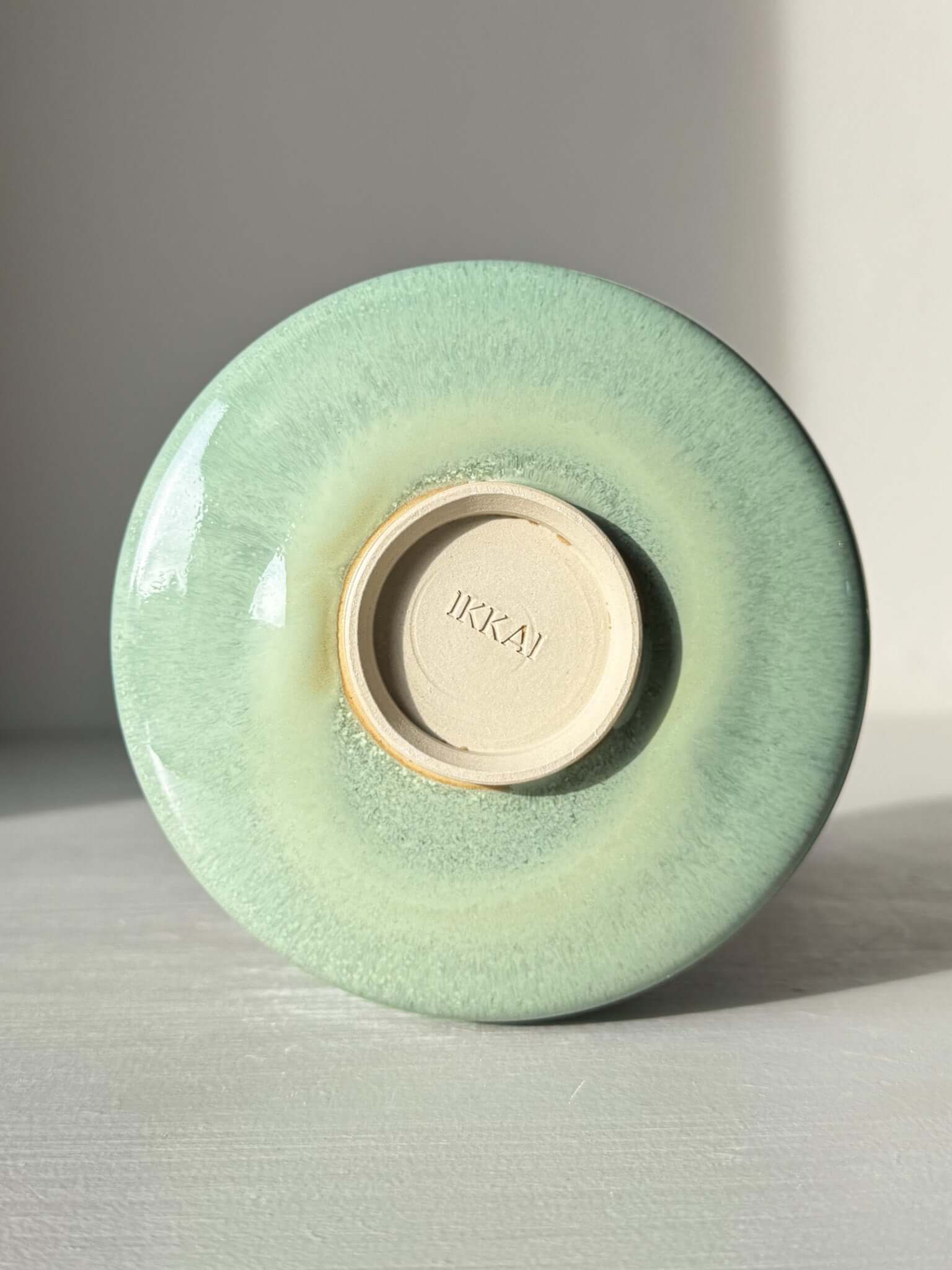 Bottom view of Matcha Bowl Spout – Sage #03 showing sage-green glaze and maker's mark.