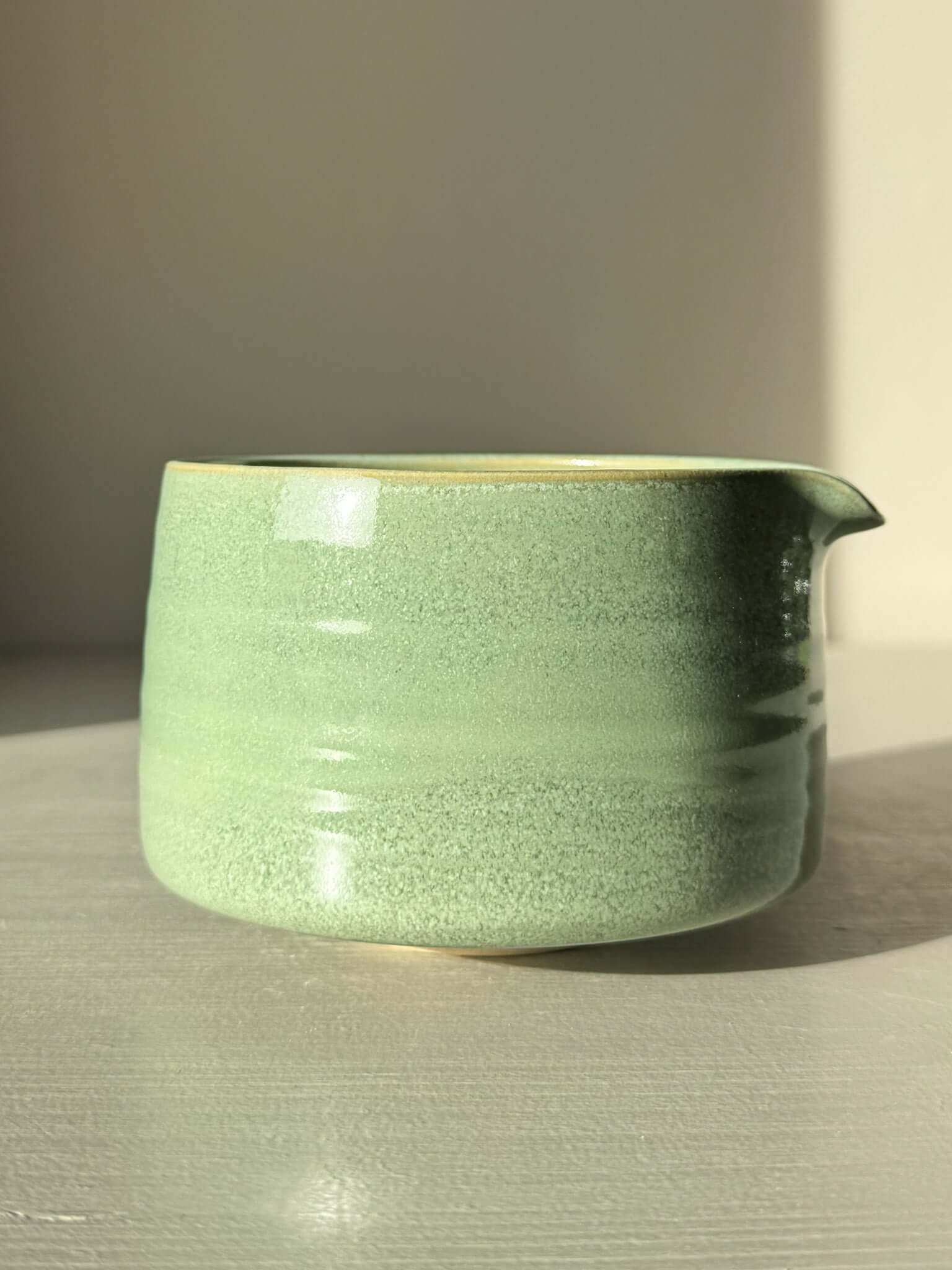 Matcha Bowl Spout – Sage #02 with sage-green glaze on a sunny surface, highlighting the smooth, open design perfect for whisking matcha.