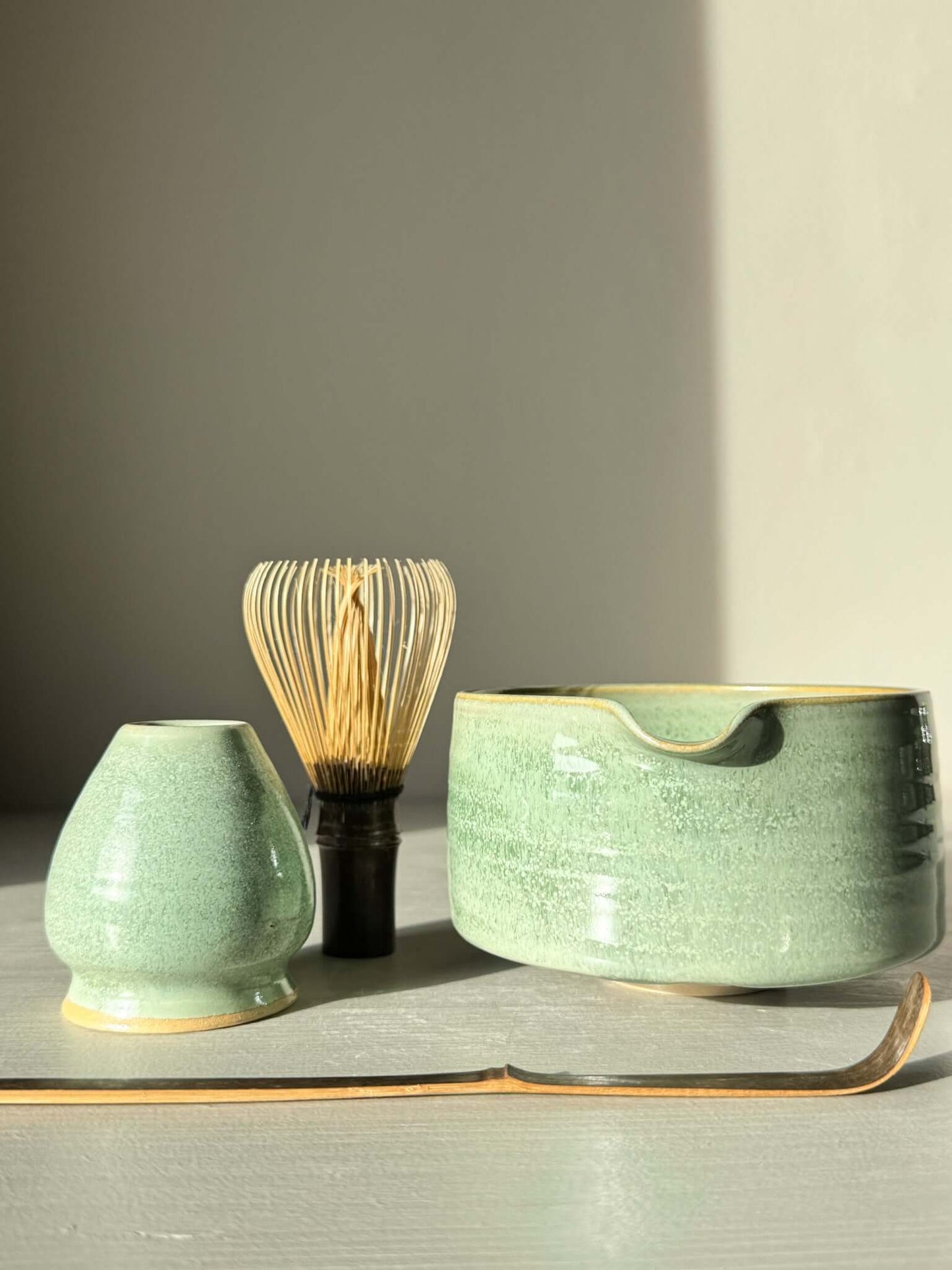 Matcha Bowl Spout – Sage #01 with whisk and accessory in soft sage-green glaze on display