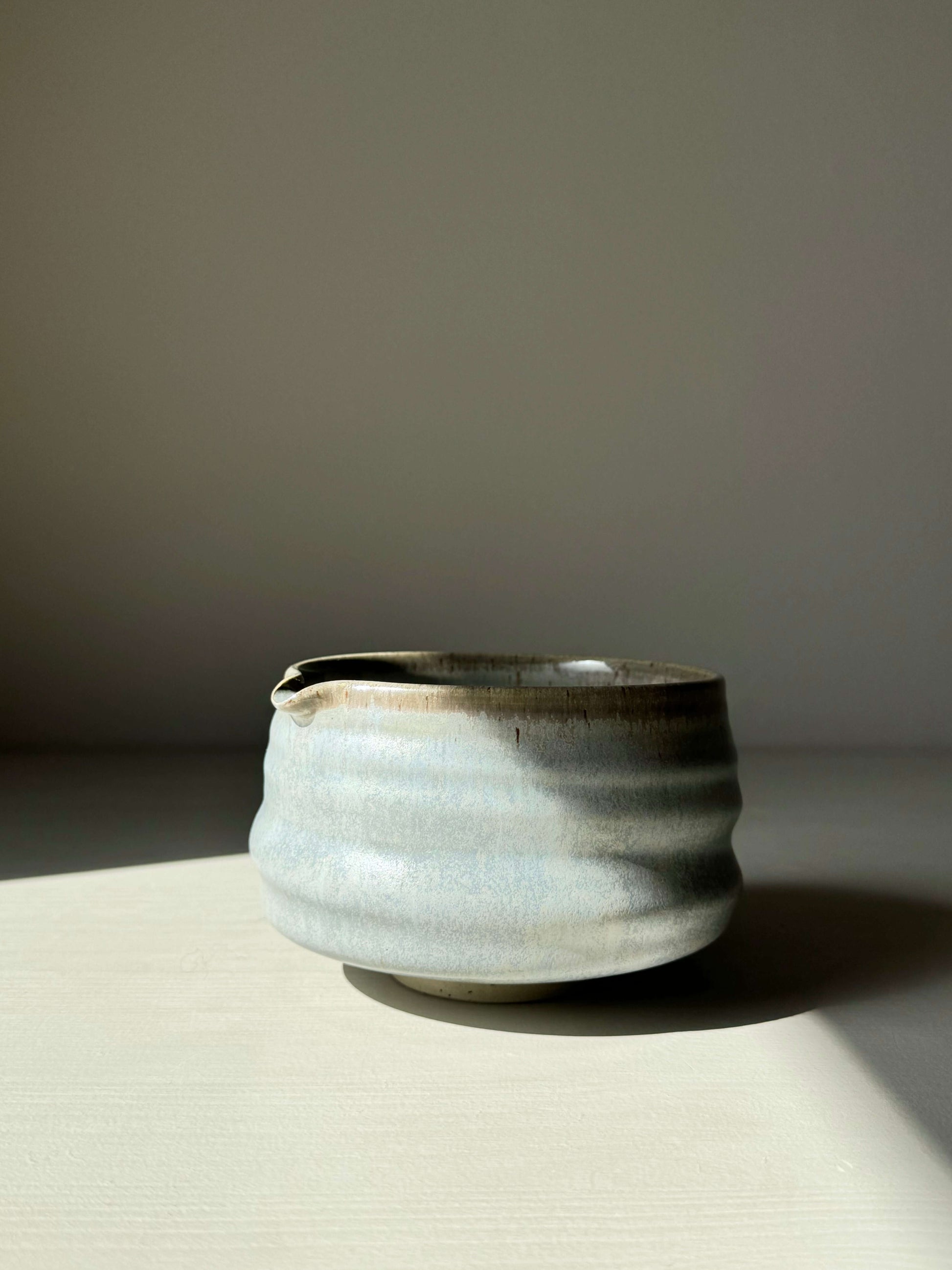 Sky blue glazed matcha bowl with spout and ridged shape, perfect for whisking. Unique, calming design in serene, natural tones.