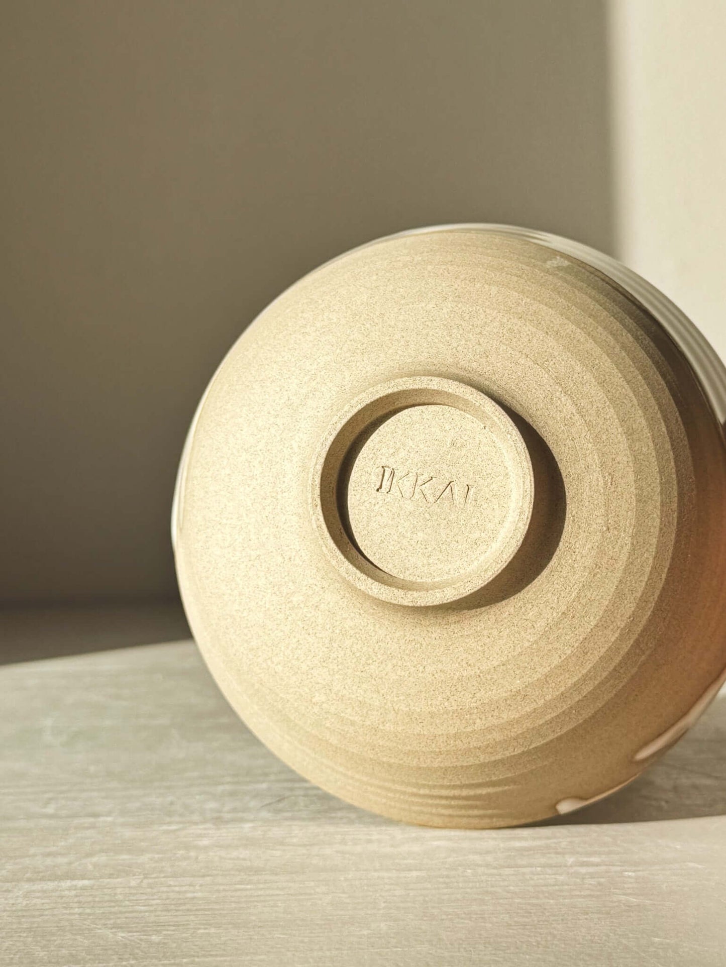 Underside of Small Bowl - Yuki with natural clay and soft glaze details.