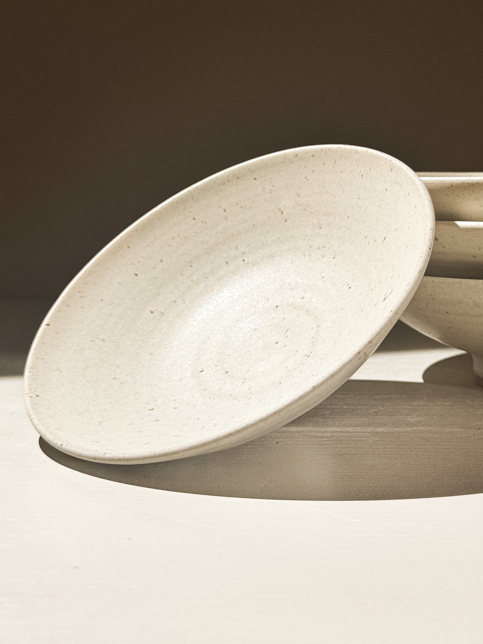 Small Footed Serving Bowl – Eggshell with a soft matte finish and speckled stoneware clay.