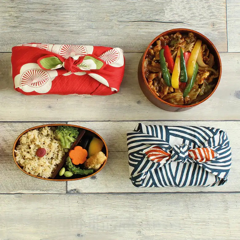 Small Furoshiki showcasing three wrapped bento boxes in vibrant patterns and colors, emphasizing Japanese culture.