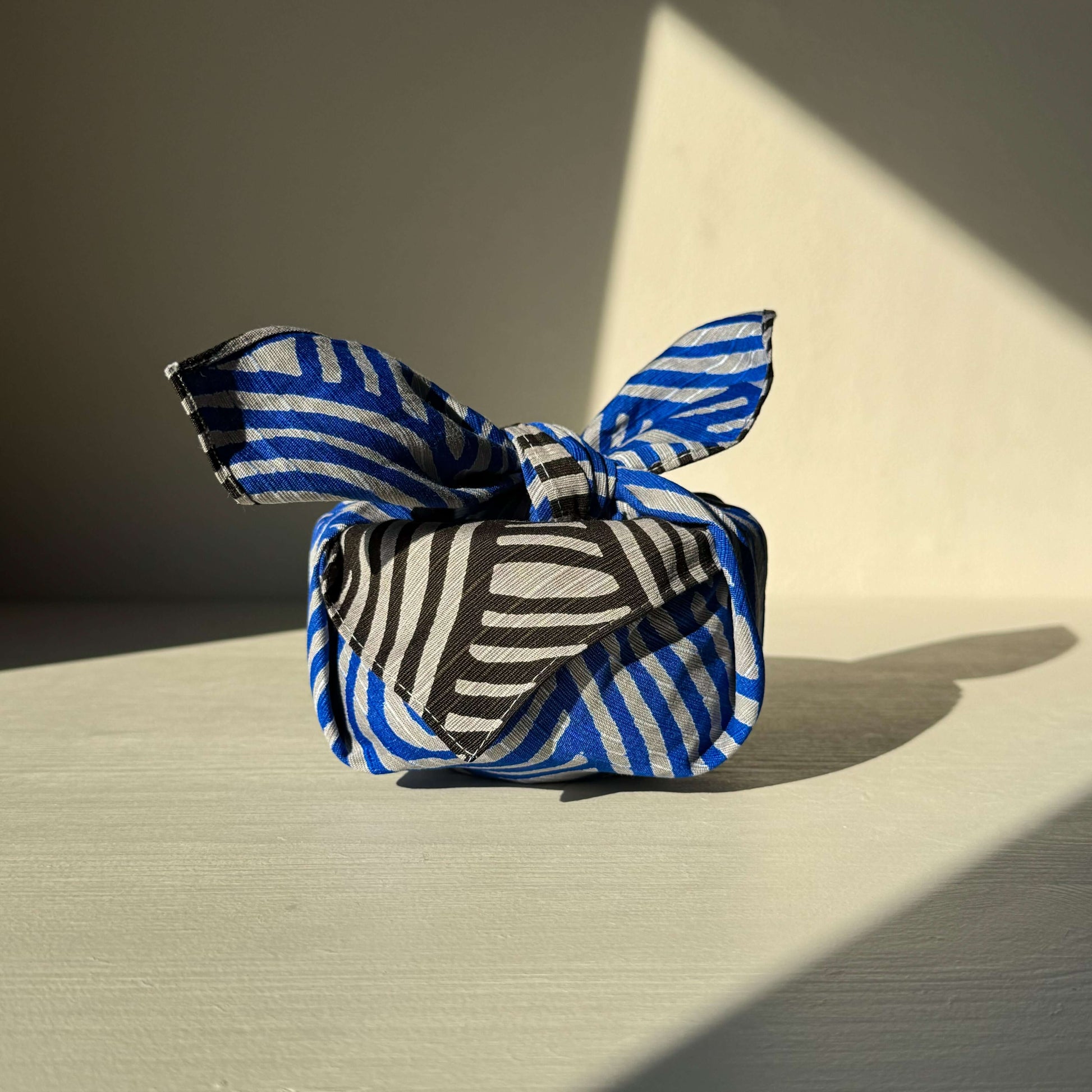 Dark gray and blue small Furoshiki, 48x48 cm, crafted with 100% cotton, featuring unique Isa Monyo Connection design for wrapping and decor.