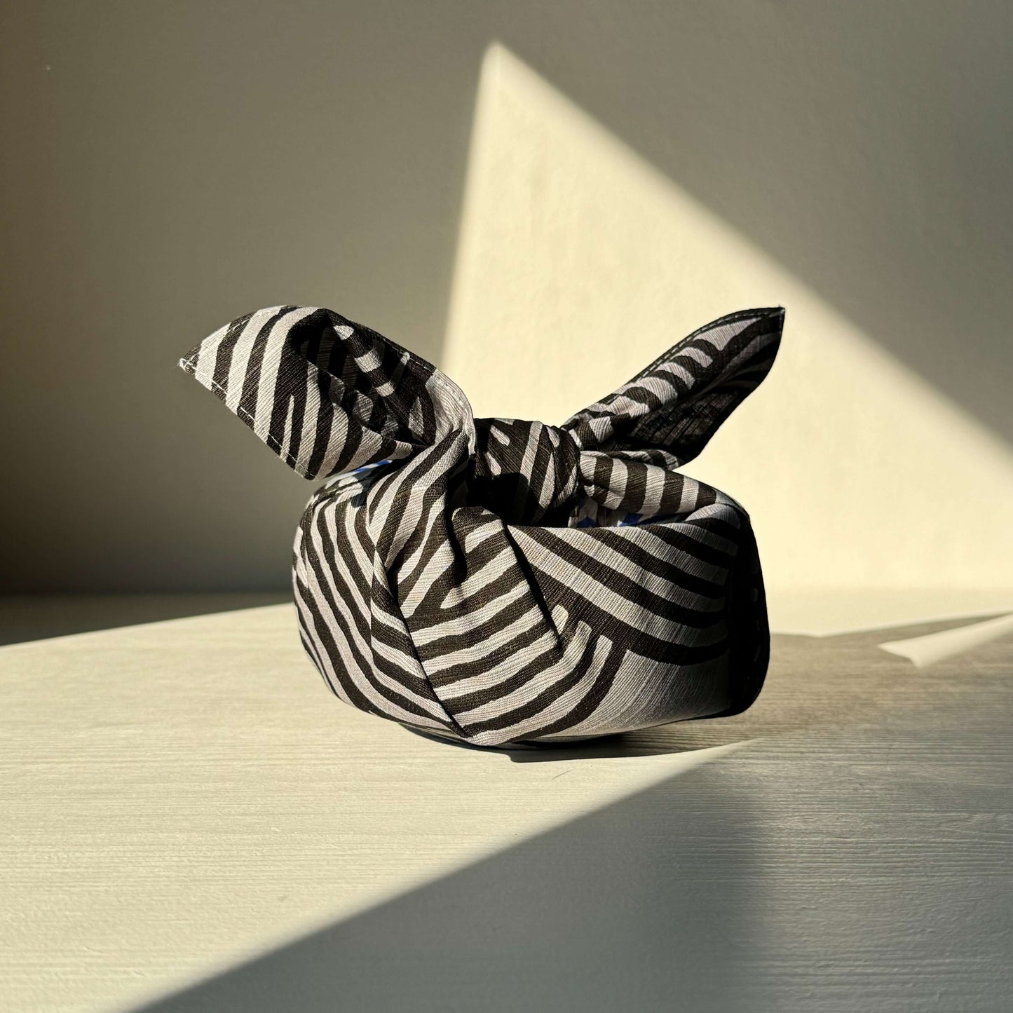 Dark gray and blue small Furoshiki wrap with striped pattern, 100% cotton, 48 cm square, topstitched for durability and style.