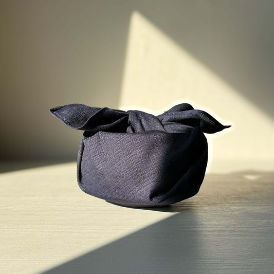 Small Furoshiki in dark indigo made from organic cotton, shown as versatile gift wrapping solution.