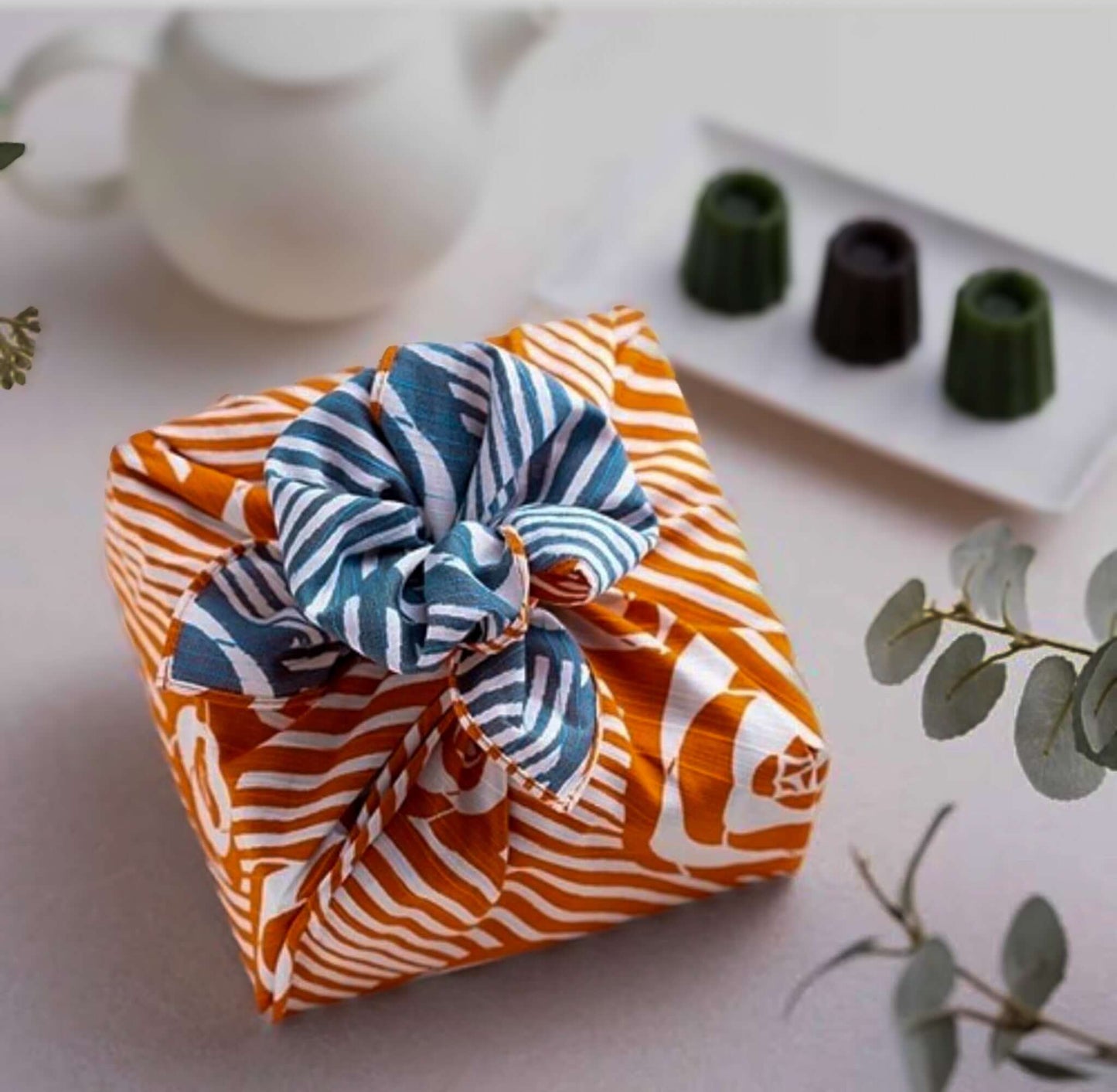 Small Furoshiki isa monyo with camellia pattern, orange and blue design perfect for gift wrapping.