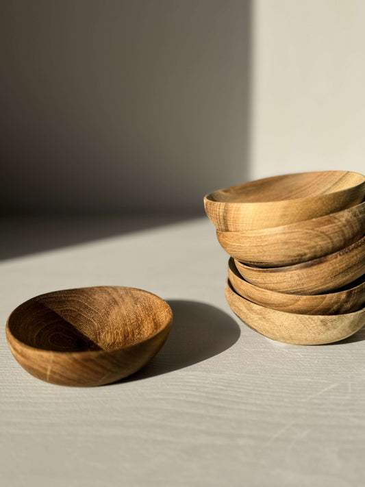 Hand-carved small walnut wood bowls with unique grains, inspired by Marrakech, perfect for tea moments.