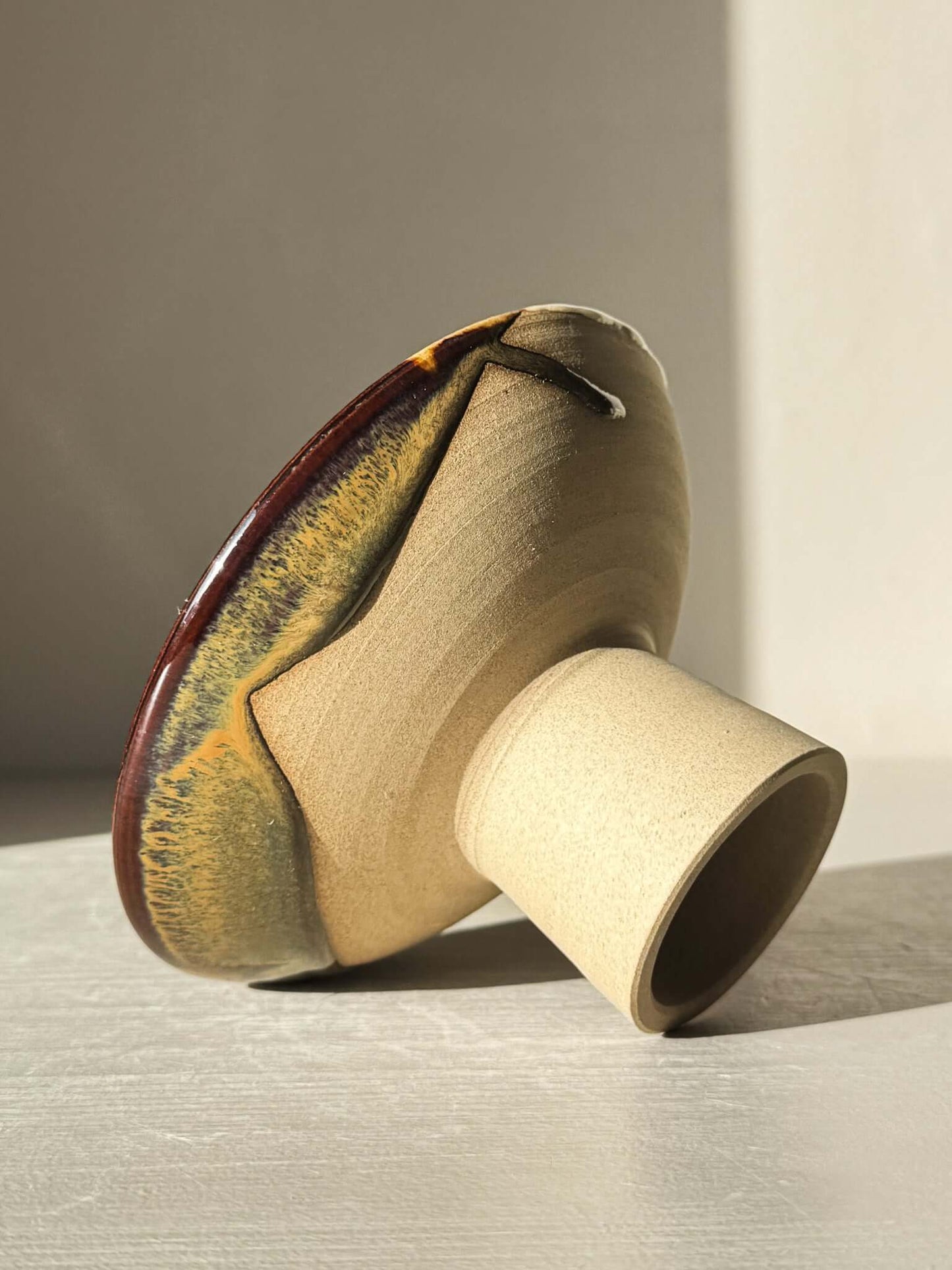 Small Pedestal Bowl - Inyo #01 with sculptural form and dripped glaze in warm gold, rich brown, blue, and green hues.