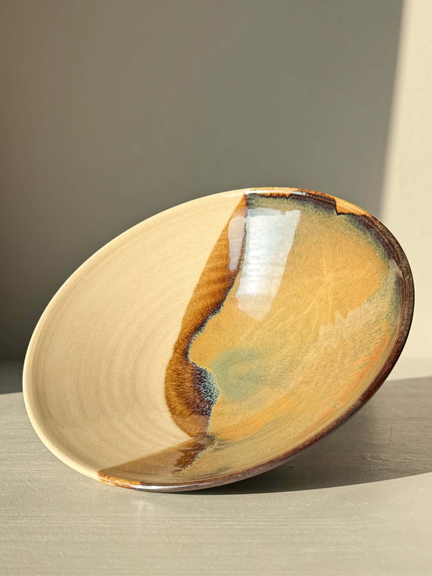 Small Serving Bowl - Inyo Series #01 in handmade ceramic with tenmoku, amber, and blue glaze on a raw clay base.