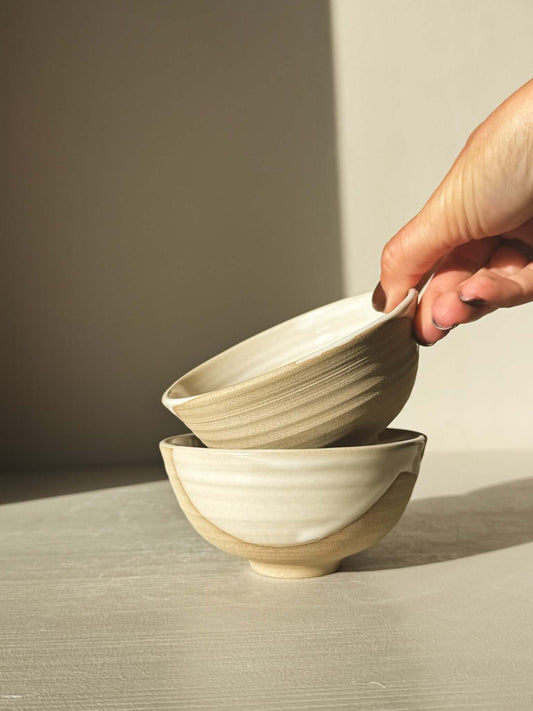 Hand holding stack of two Small Bowl - Yuki with white glaze and warm clay texture