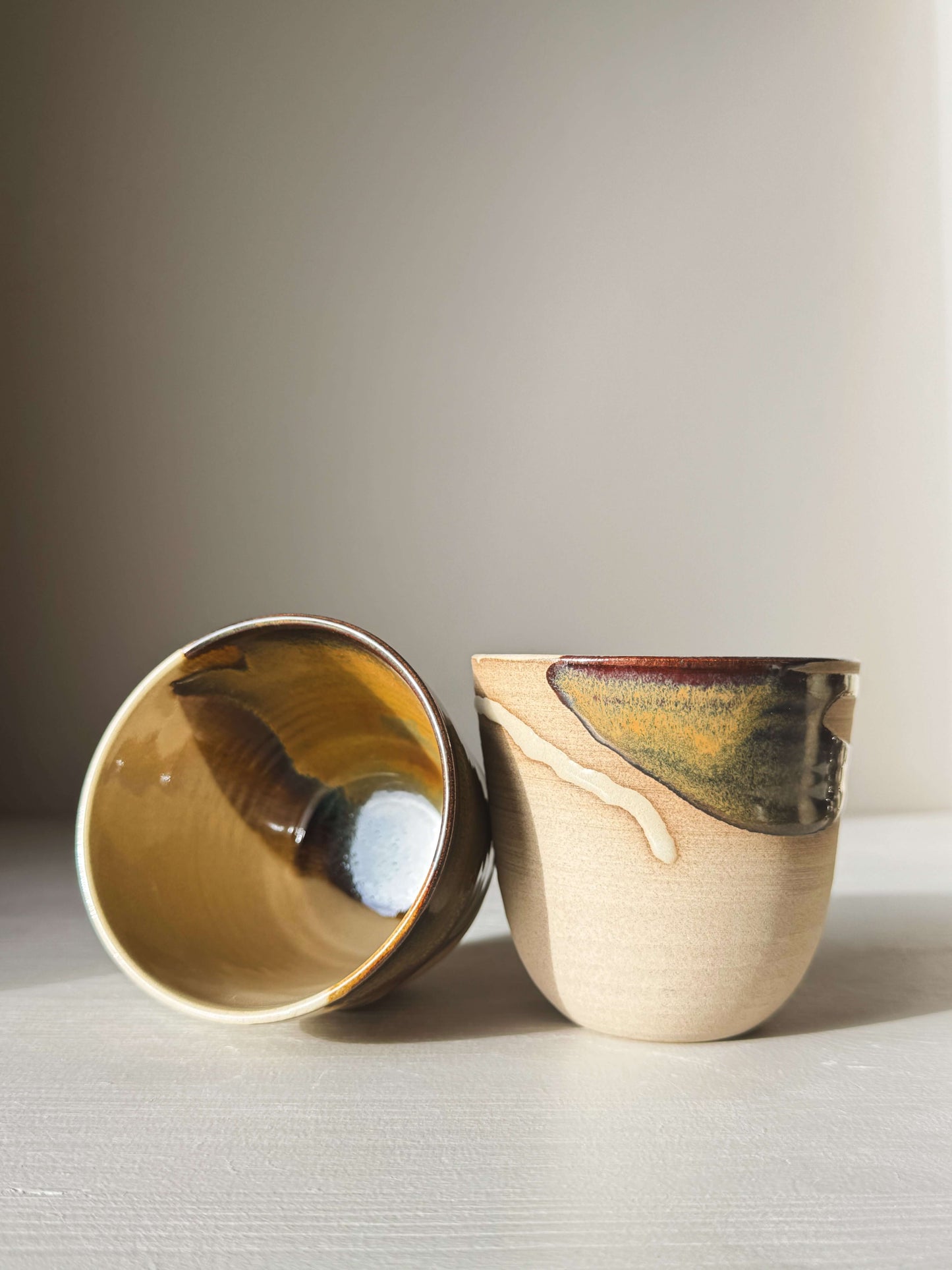 Stackable Latte Cups - Inyo showcasing wheel-thrown design with deep tenmoku and clear glaze, perfect for everyday use and easy stacking.