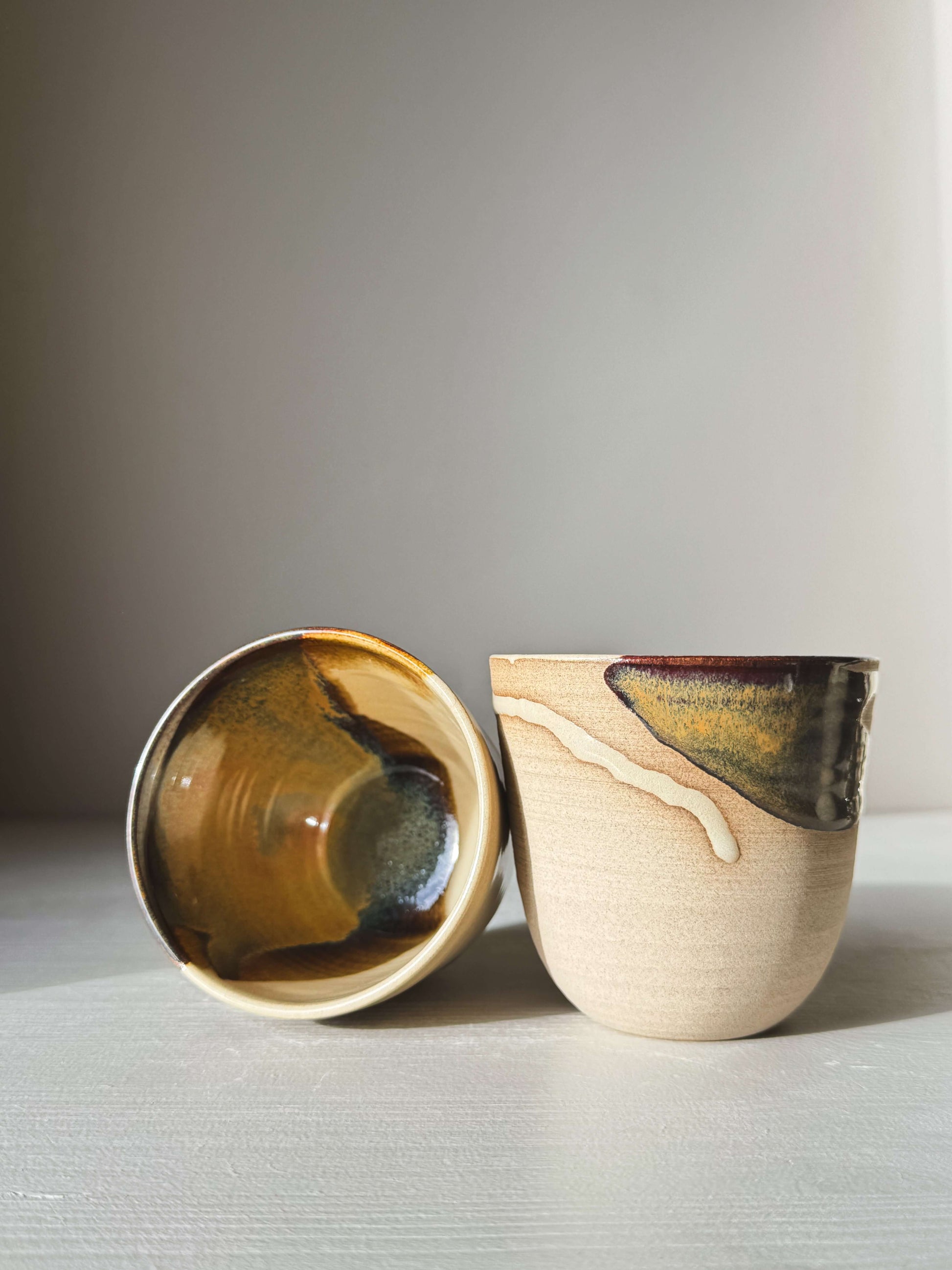 Stackable Latte Cups - Inyo with handmade glazes displayed on a table.