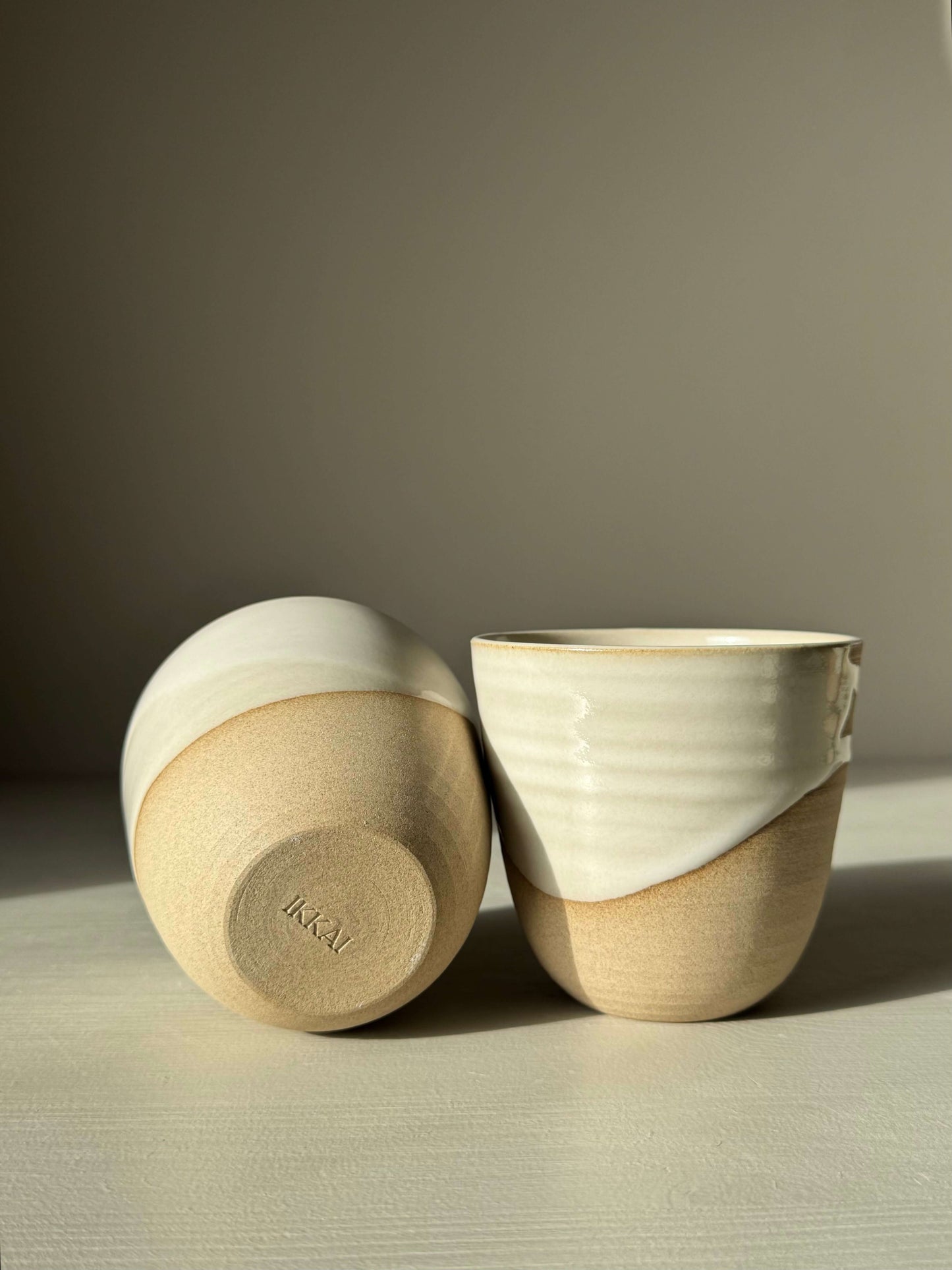 Stackable Latte Cups - Yuki handmade ceramic with glossy white glaze and toffee clay, showcasing stackable design and handcrafted elegance.