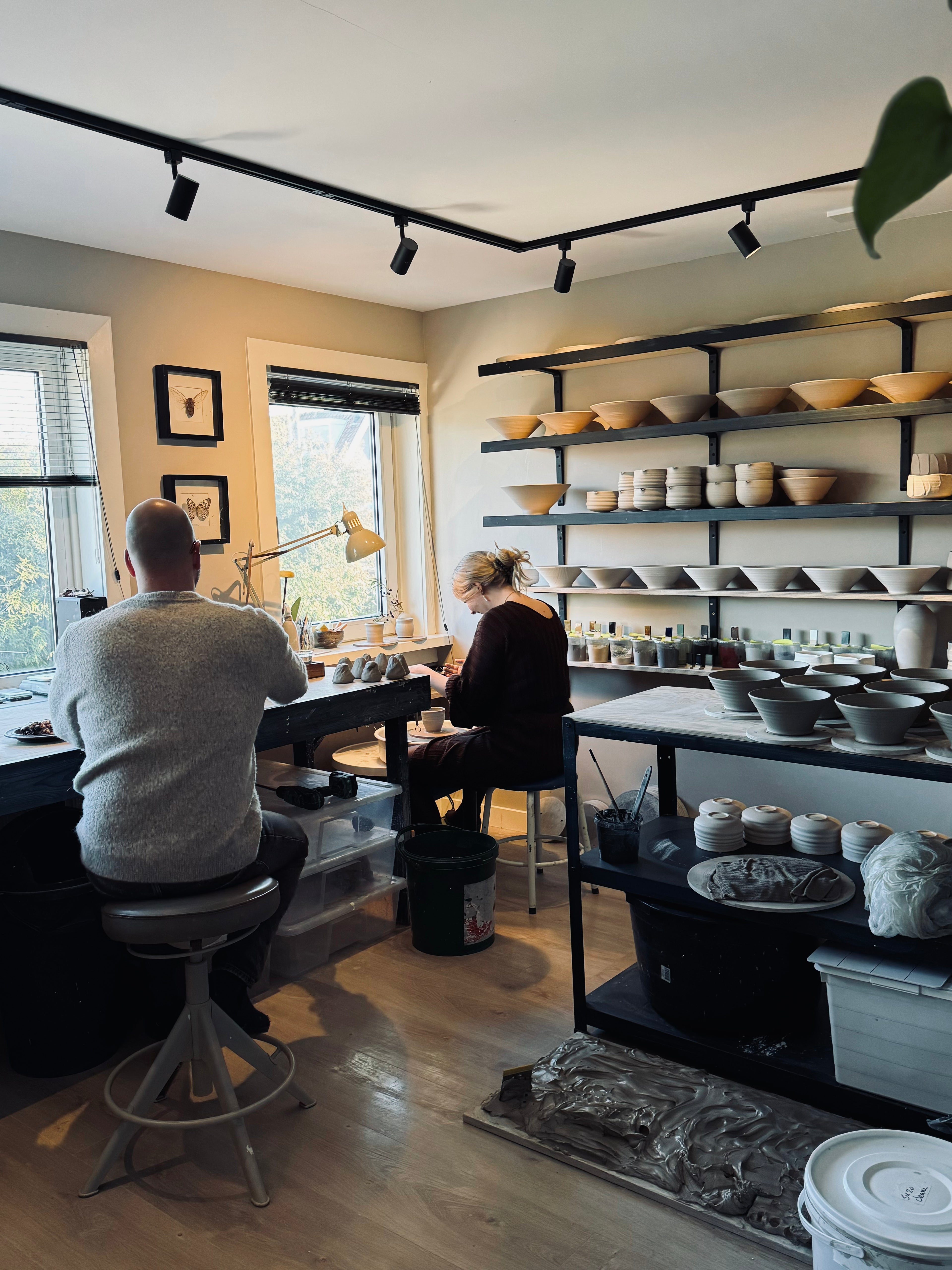 Student shaping clay on a pottery wheel during a private lesson at IKKAI Ceramics studio.