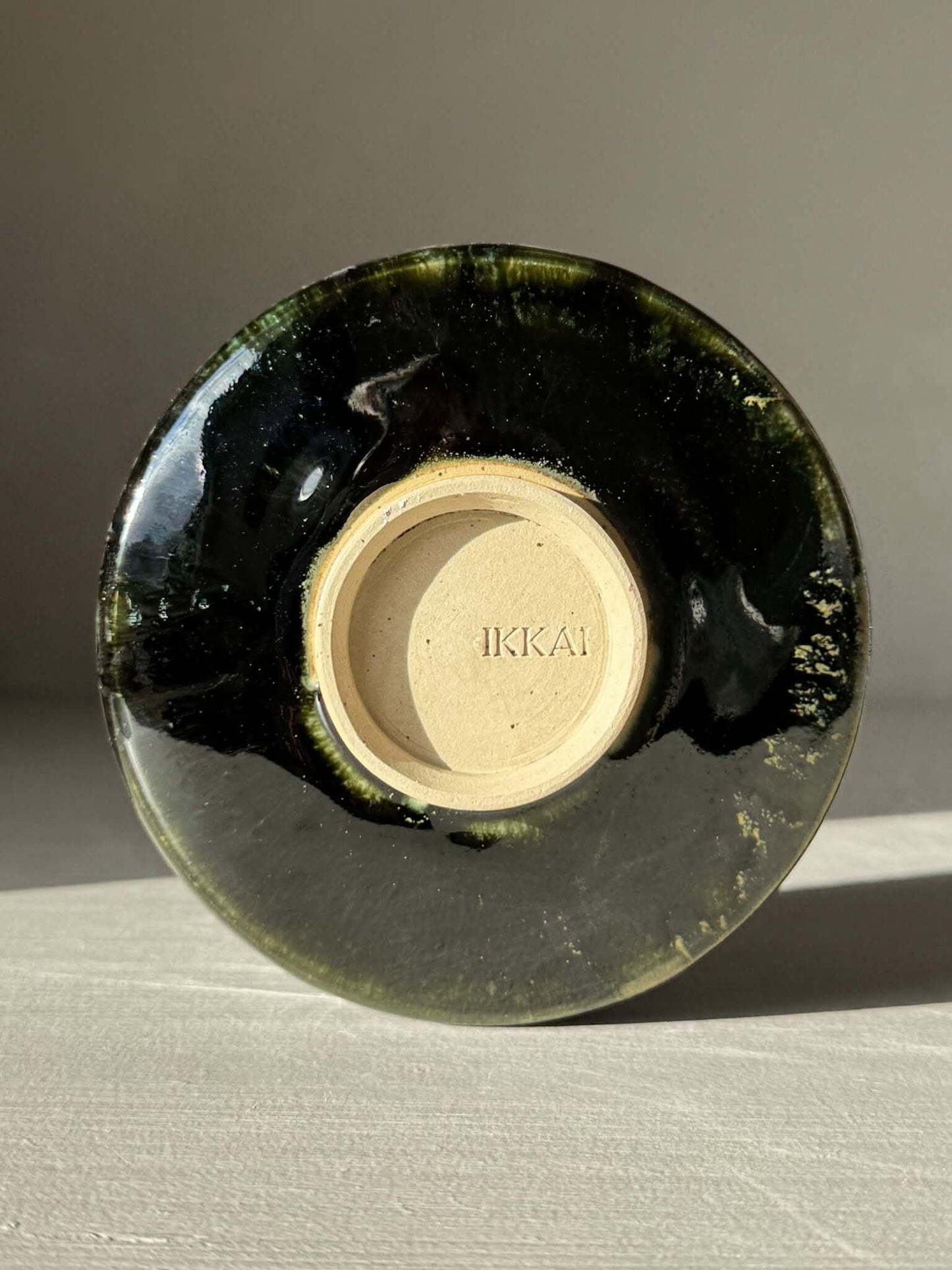 Bottom view of Textured Matcha Bowl Spout - Hinoki #01 with glossy green glaze and subtle ridges highlighting the craftsmanship.
