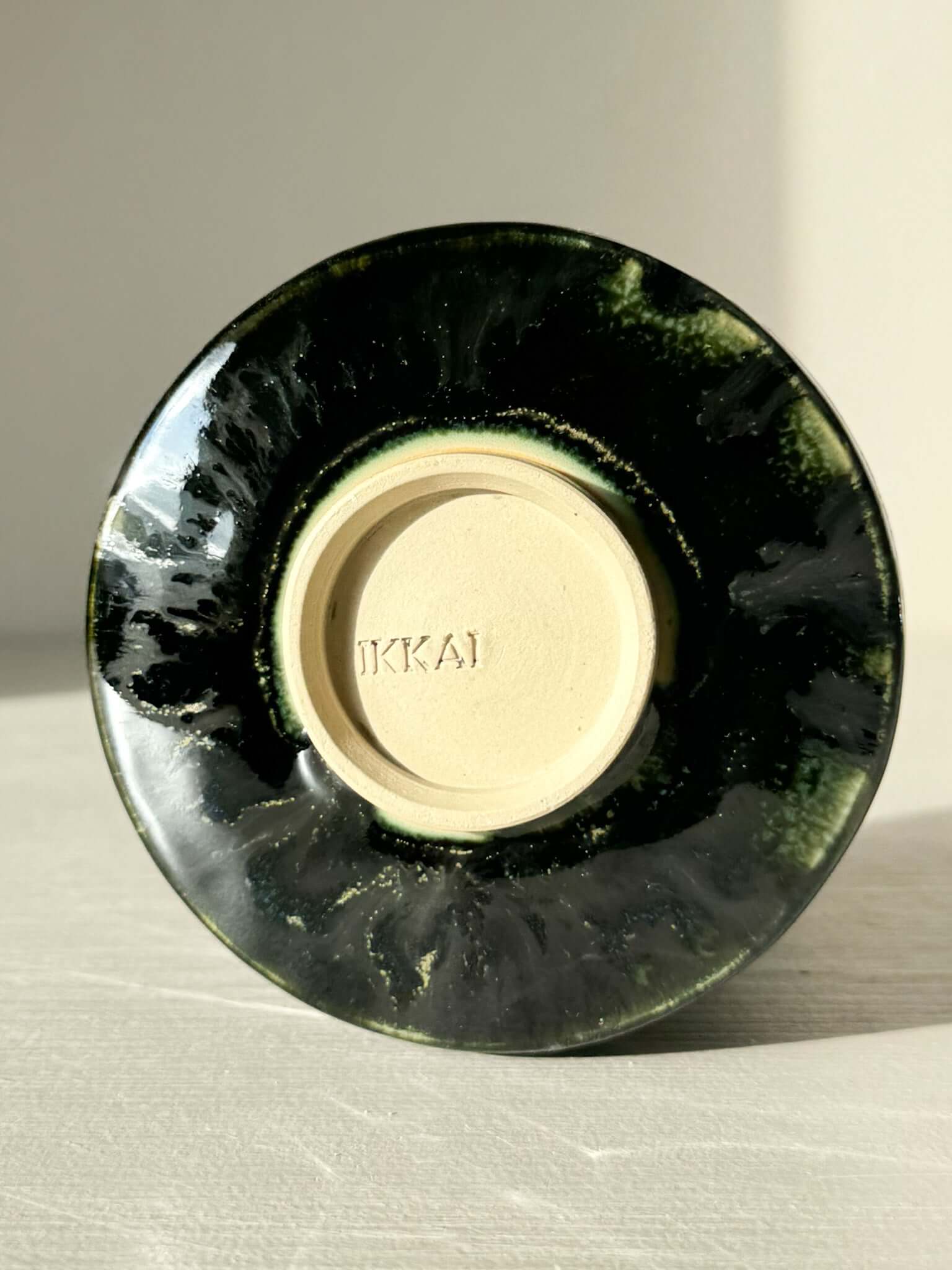 Underside view of Textured Matcha Bowl - Hinoki #19 with green glaze and unique texture, part of artisan Hinoki Series.
