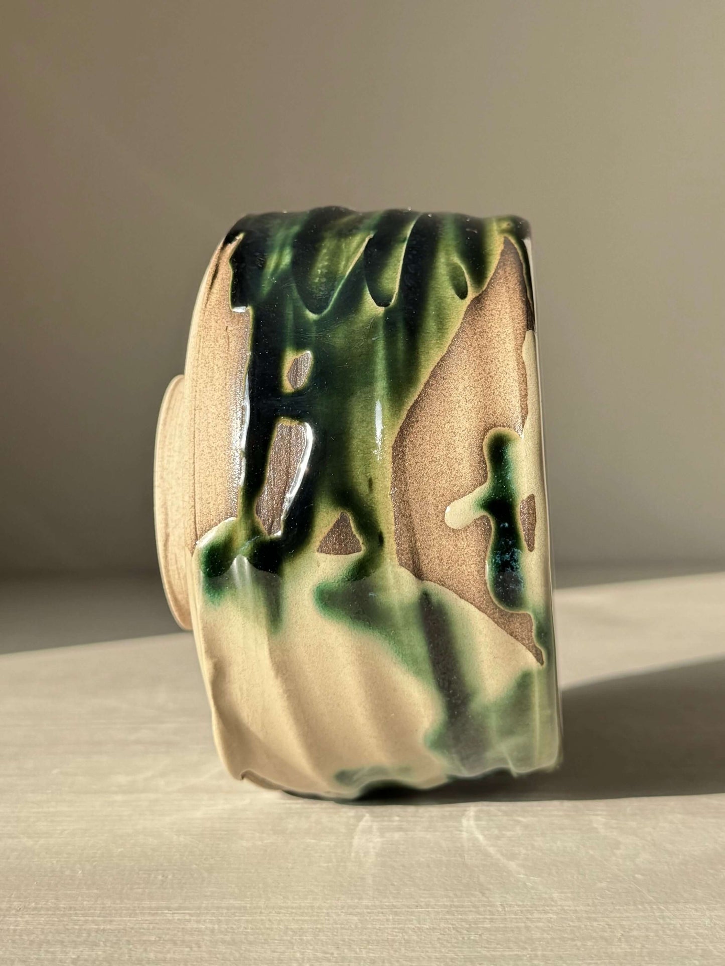 Textured Matcha Bowl – Mori #02 with handmade ceramic design and forest-green glaze on a natural clay surface.