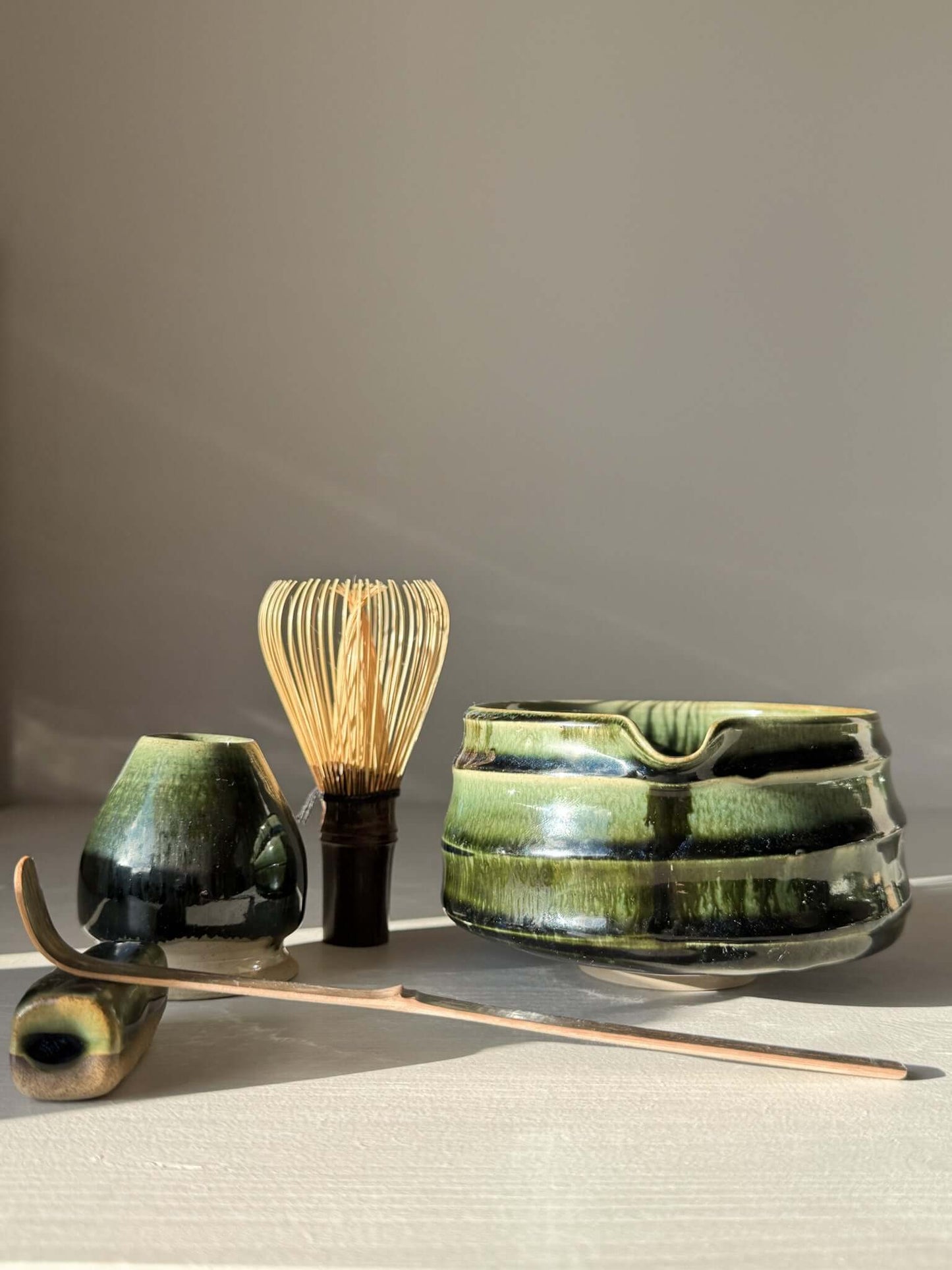 Textured Matcha Bowl Spout - Hinoki #02 with whisk and ladle, showcasing glossy green glaze and tactile design