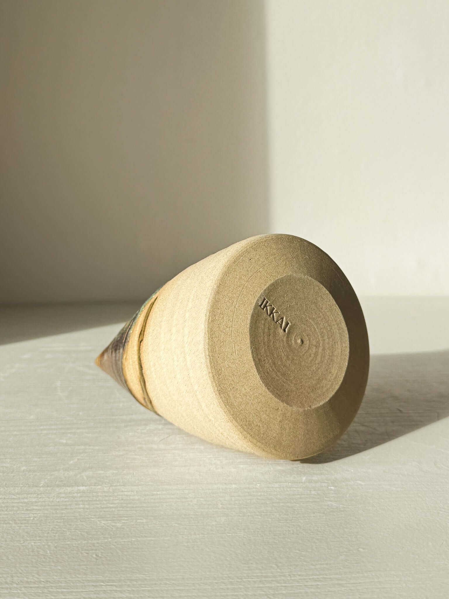 Textured Ceramic Tree – Inyo #03 laying sideways, showcasing the natural throwing lines and earth-toned tenmoku glaze details.