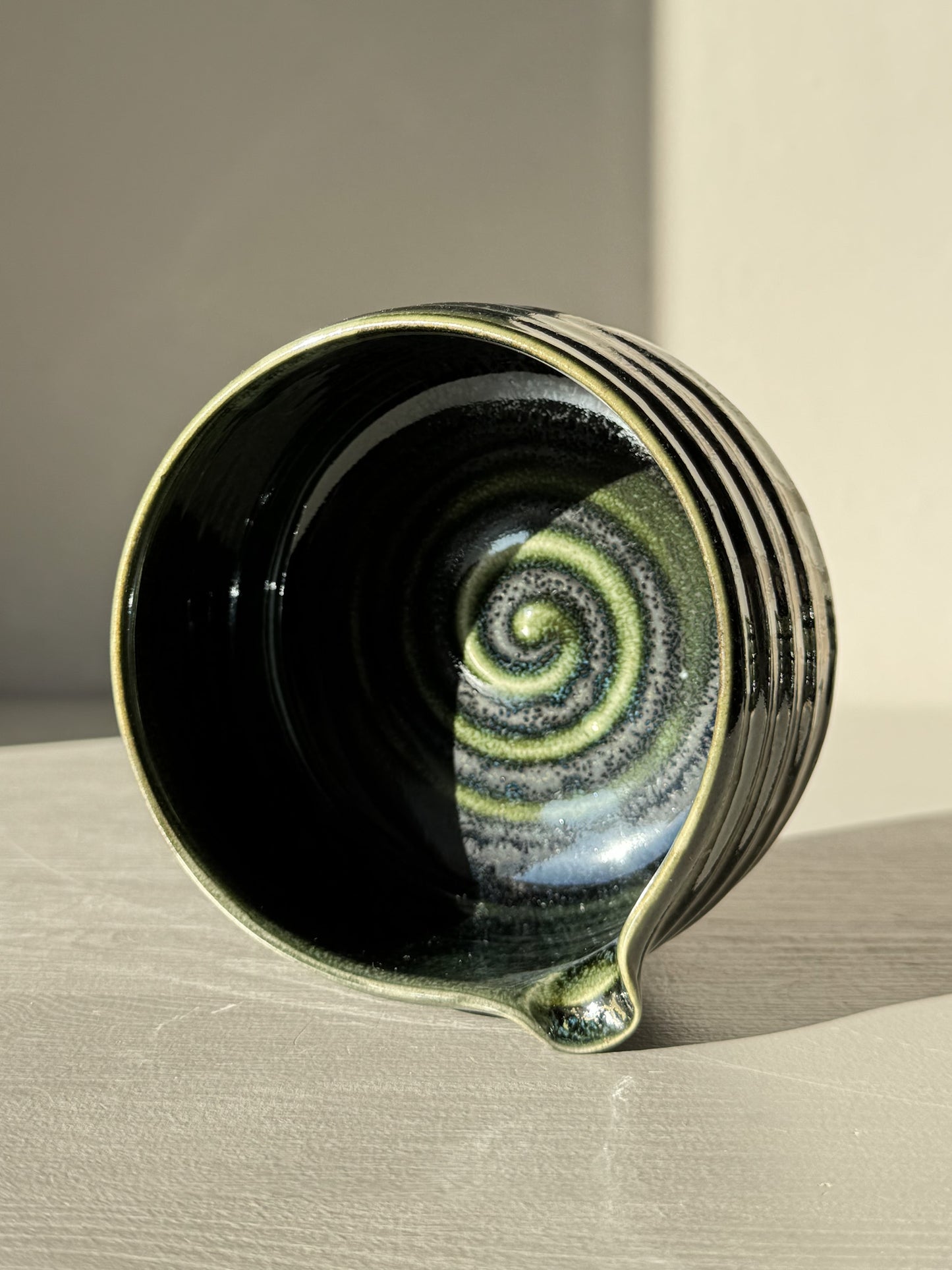 Textured Matcha Bowl Spout - Hinoki #05 with a glossy green glaze and pouring spout, showcasing subtle ridges and tactile form.