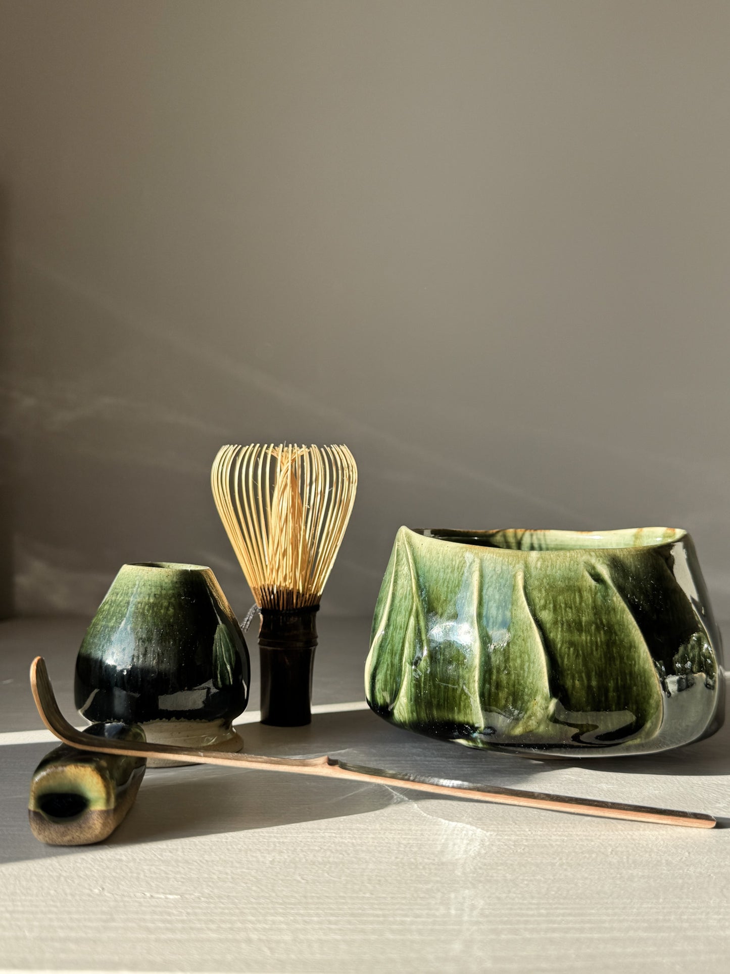 Textured Matcha Bowl - Hinoki #05 with green glaze, part of Hinoki Series, alongside matcha whisk and accessories.