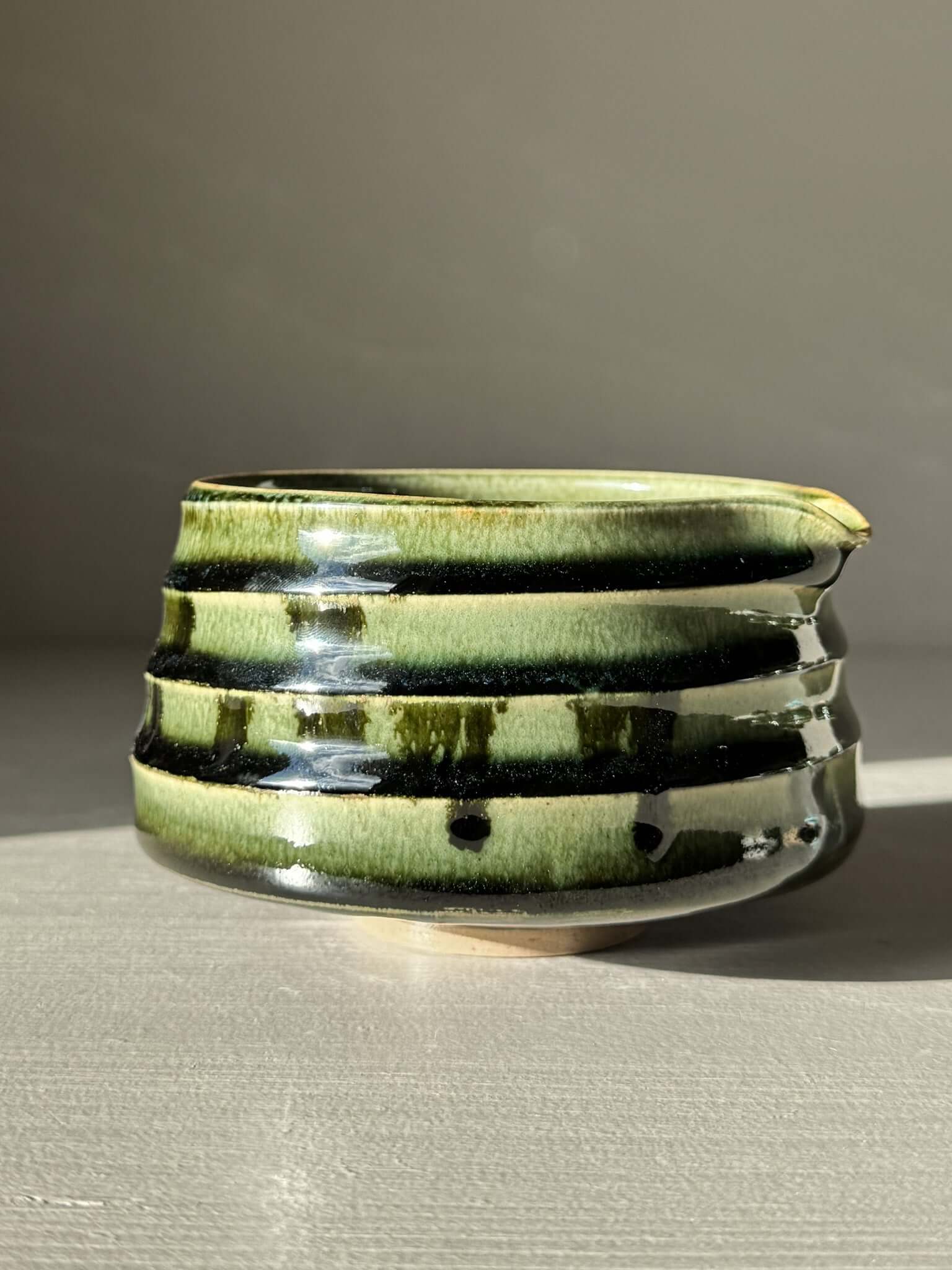 Textured Matcha Bowl Spout - Hinoki #01 with glossy green glaze, showcasing ridges and a curved spout for easy pouring.