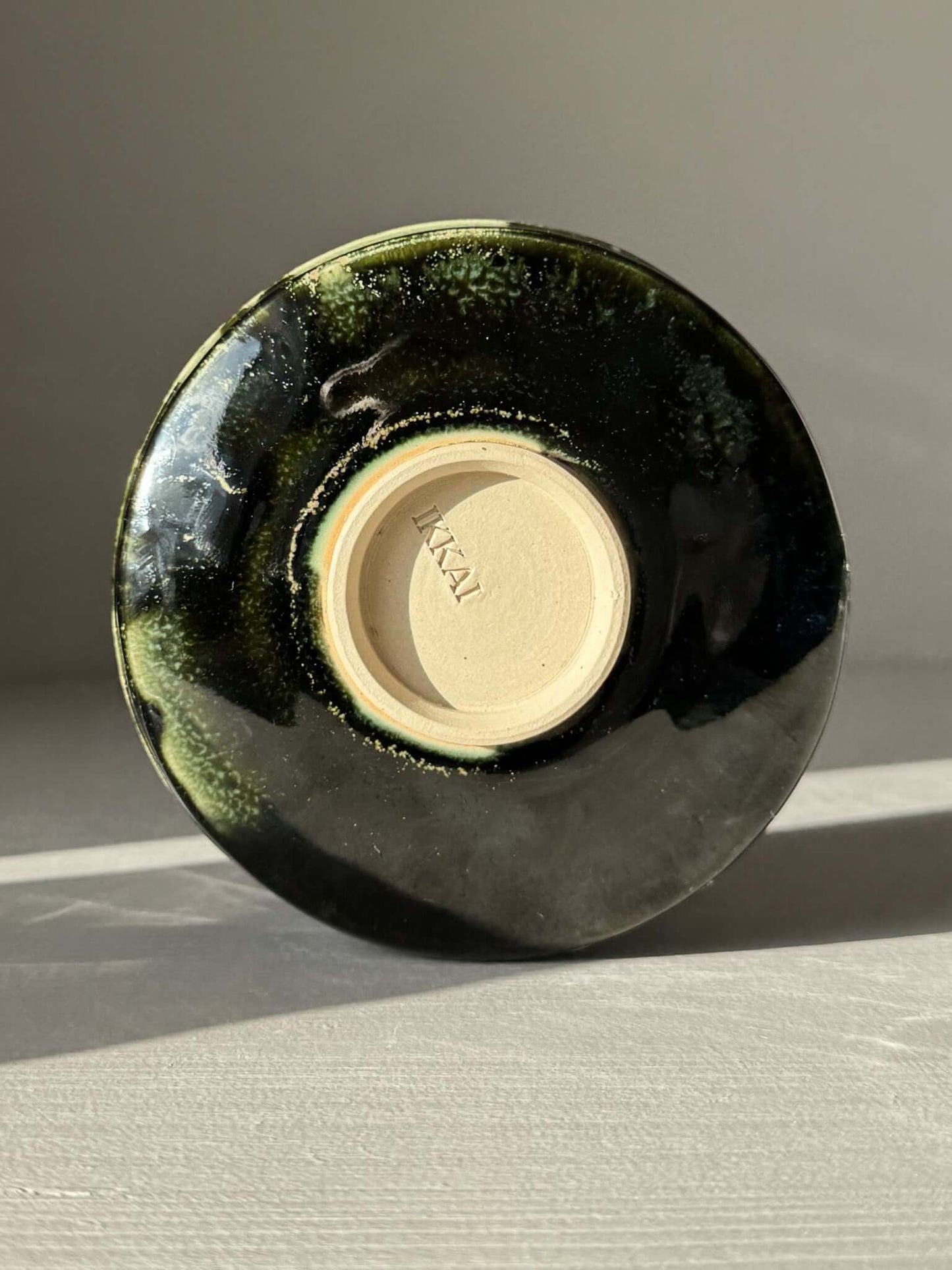 Bottom view of Textured Matcha Bowl Spout - Hinoki #02 with glossy green glaze and visible throwing lines.