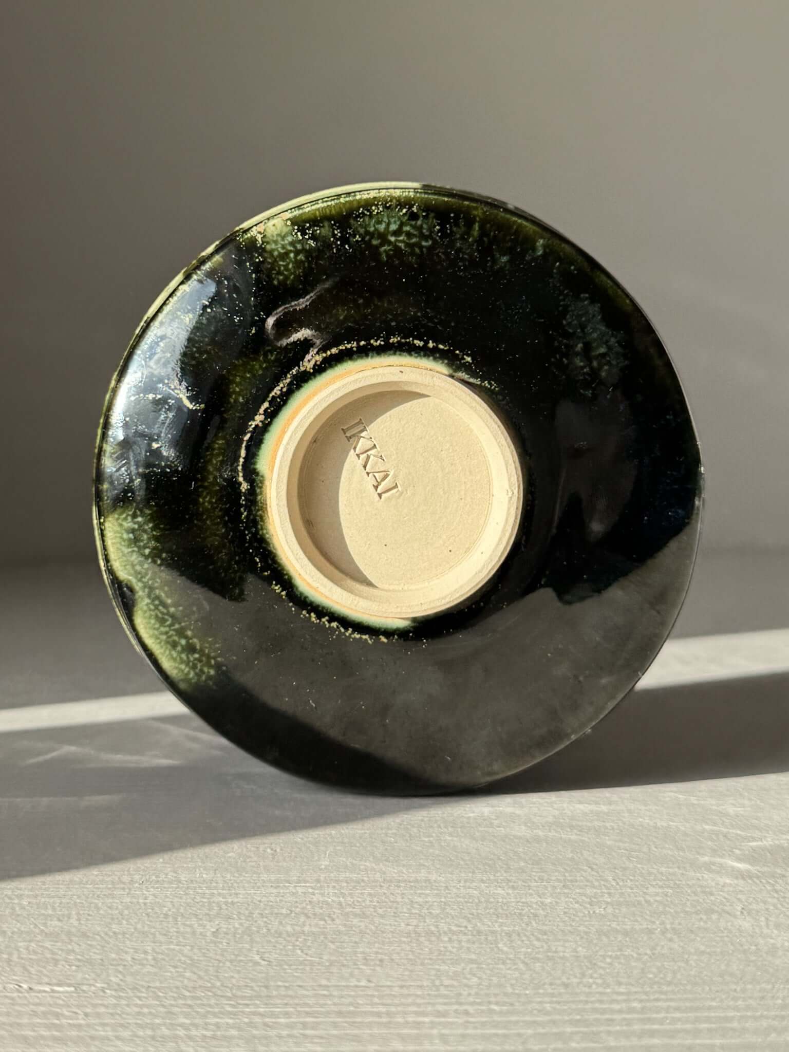 Bottom view of Textured Matcha Bowl Spout - Hinoki #02 with glossy green glaze and visible throwing lines.