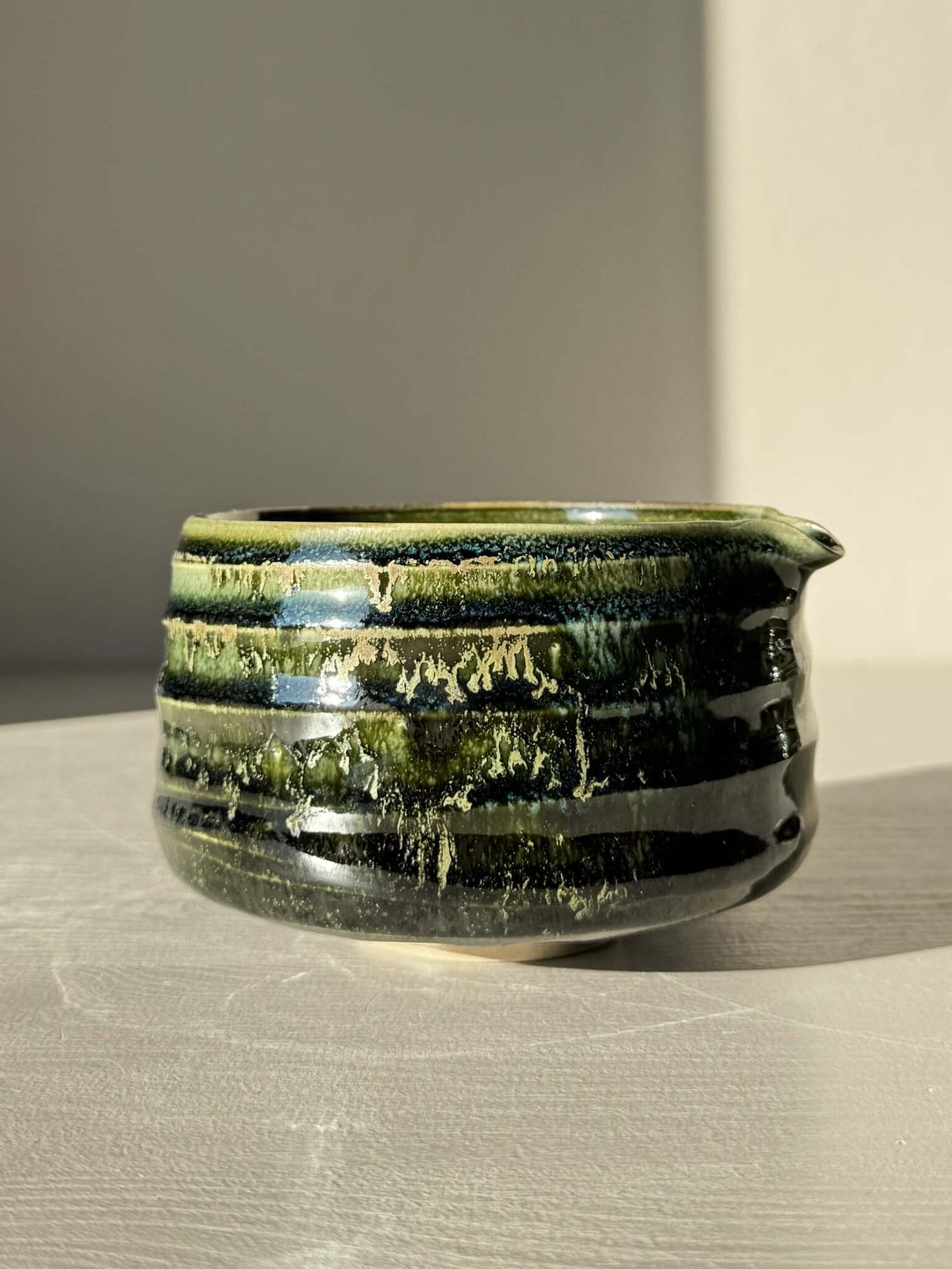 Textured Matcha Bowl Spout - Hinoki #05 with glossy green glaze and subtle ridges, showcasing throwing lines and pouring spout.