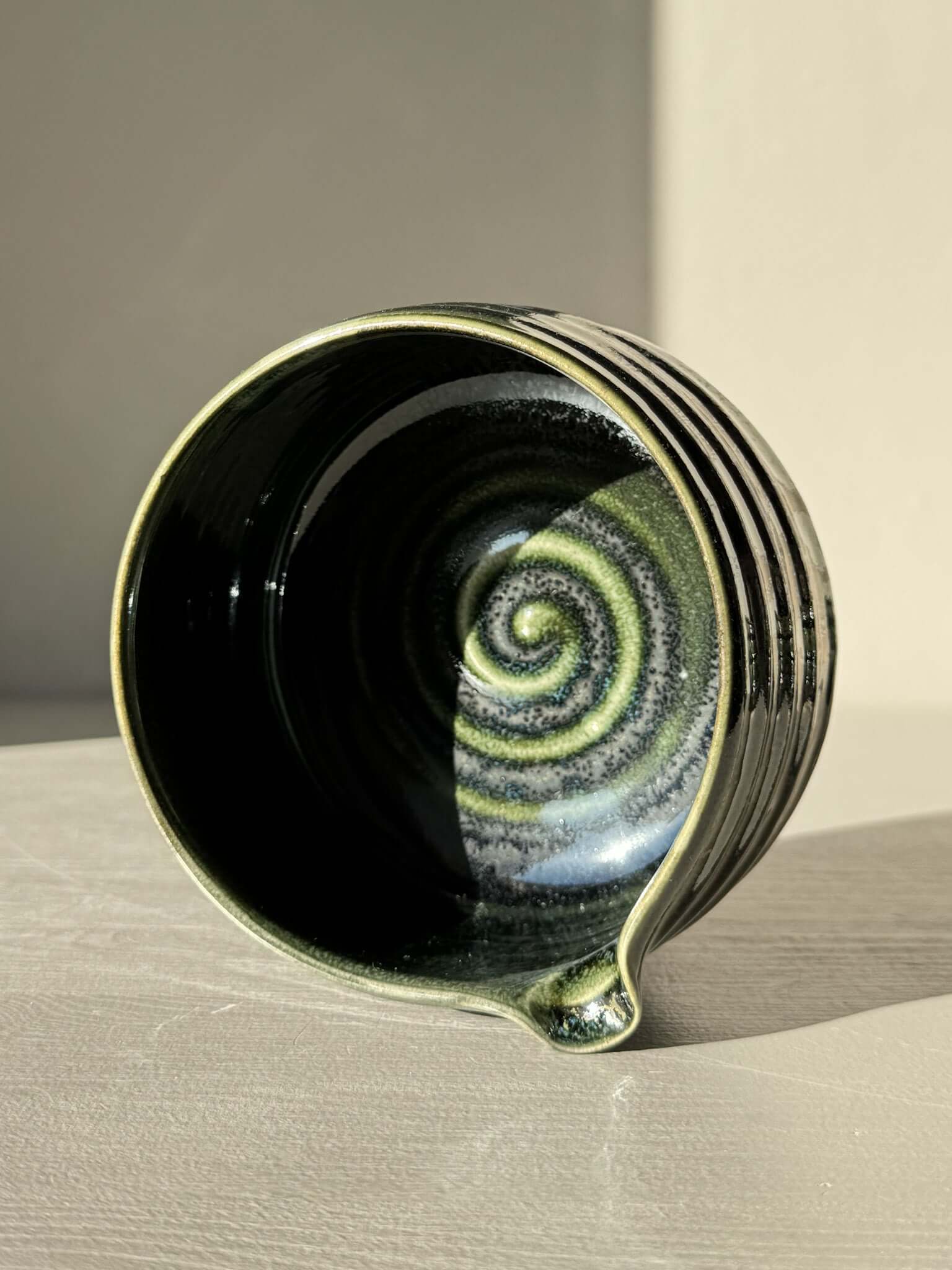 Textured Matcha Bowl Spout - Hinoki #05 with a glossy green glaze and pouring spout, showcasing subtle ridges and tactile form.