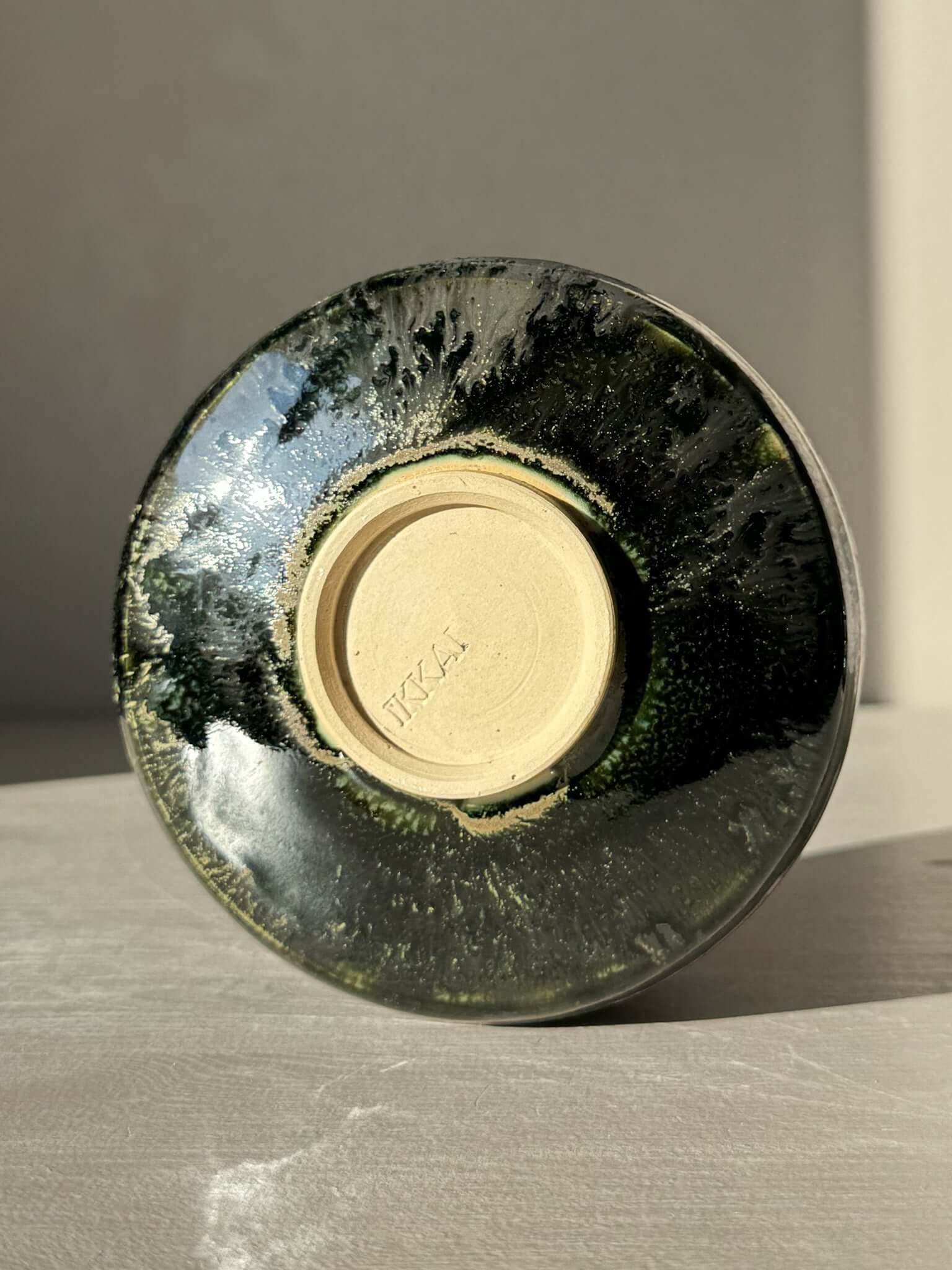 Bottom view of Textured Matcha Bowl Spout - Hinoki #05 with glossy green glaze and visible texture.