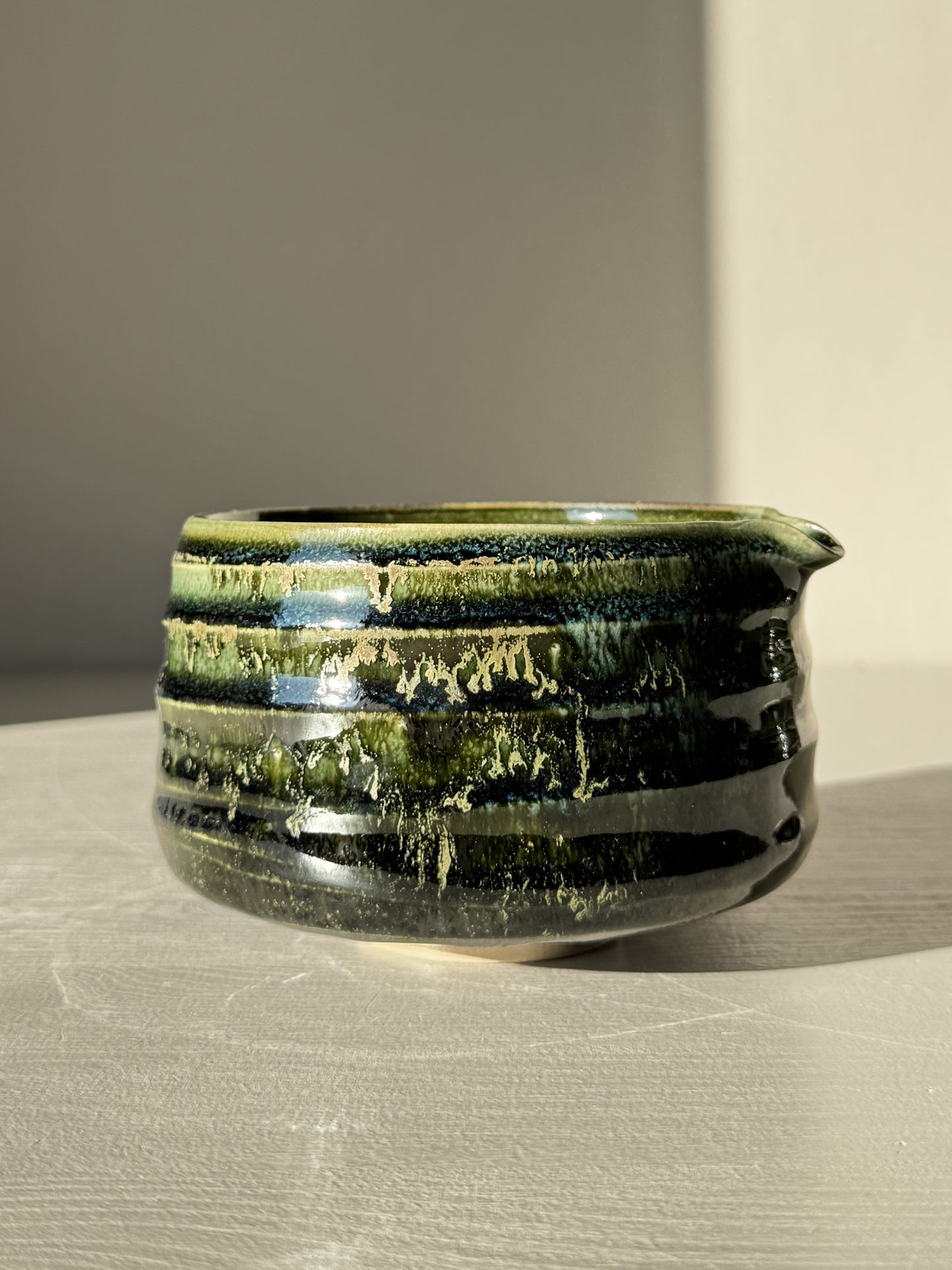 Textured Matcha Bowl Spout - Hinoki #05 with glossy green glaze and subtle ridges, showcasing throwing lines and pouring spout.