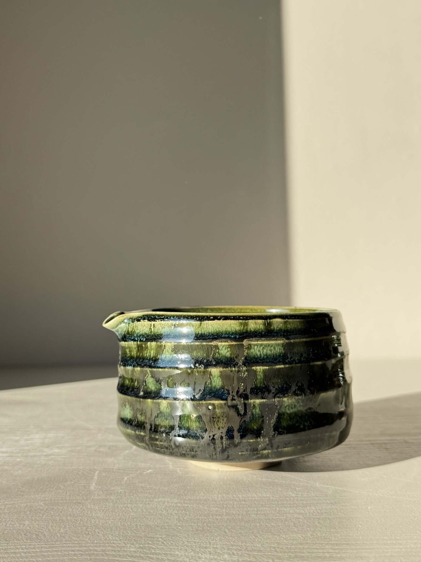 Textured Matcha Bowl Spout - Hinoki #05 in glossy green glaze with spout and ridged texture against a light backdrop.